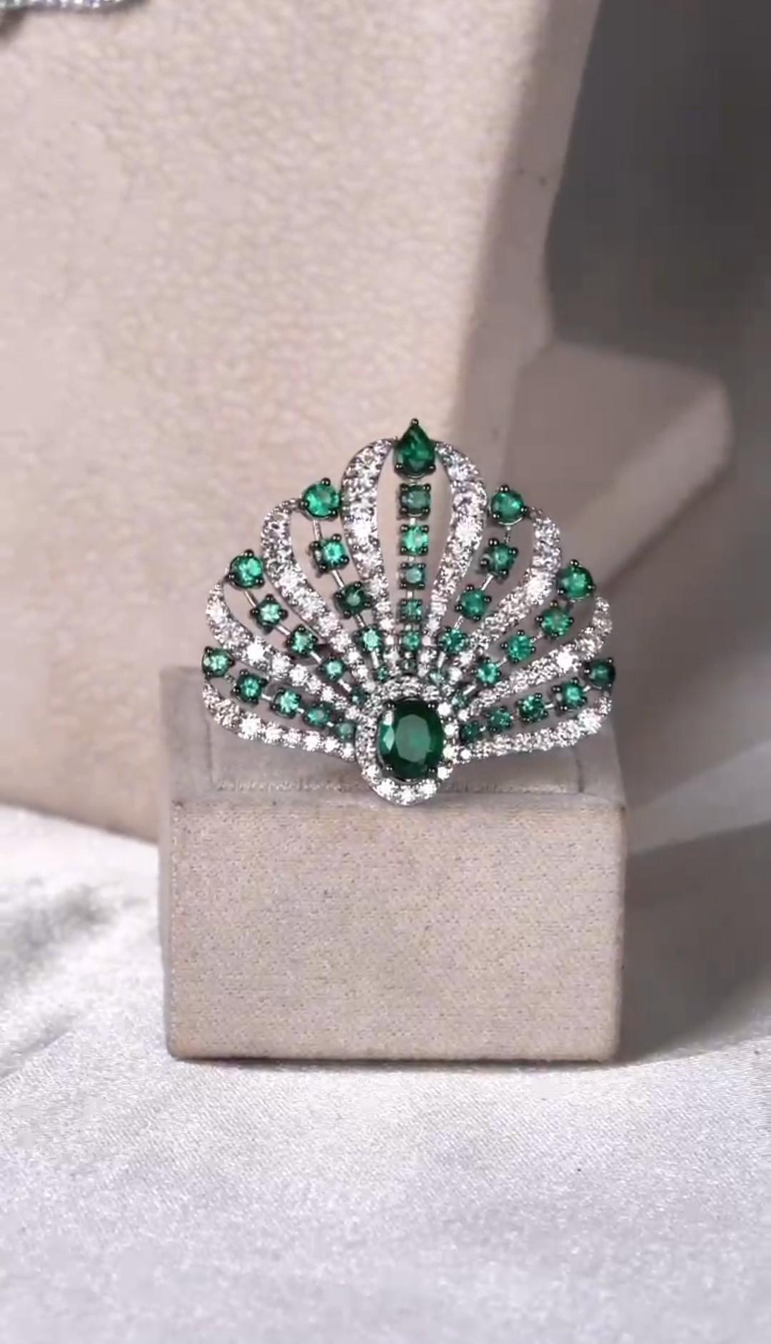 The Following Item we are offering is a Rare Important Radiant Large 18KT Gold Ring with Magnificent Large Fancy Cut Emeralds Flanked by Fine Glittering White Diamonds Throughout. T.C.W. approx 3.75CTS!!!  
This Gorgeous Ring is a Rare Sample Piece
