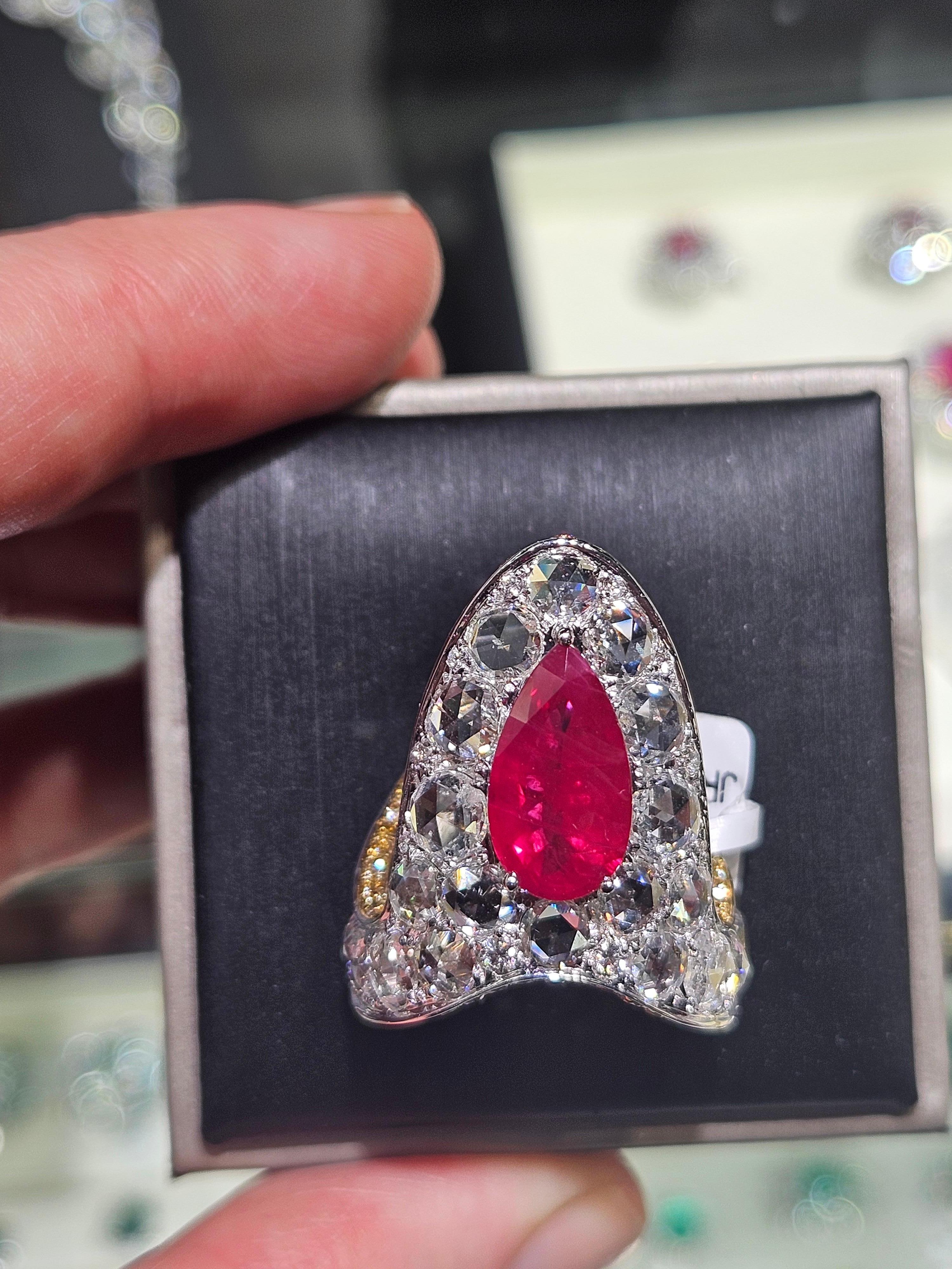 The Following Item we are offering is a Rare Important Radiant White Gold Large Fancy Manicured Nail Ruby Diamond Ring. Ring is comprised of A Gorgeous Fancy Fiery Ruby surrounded with Exquisite Glittering Rose Cut Diamonds and Fancy Colored