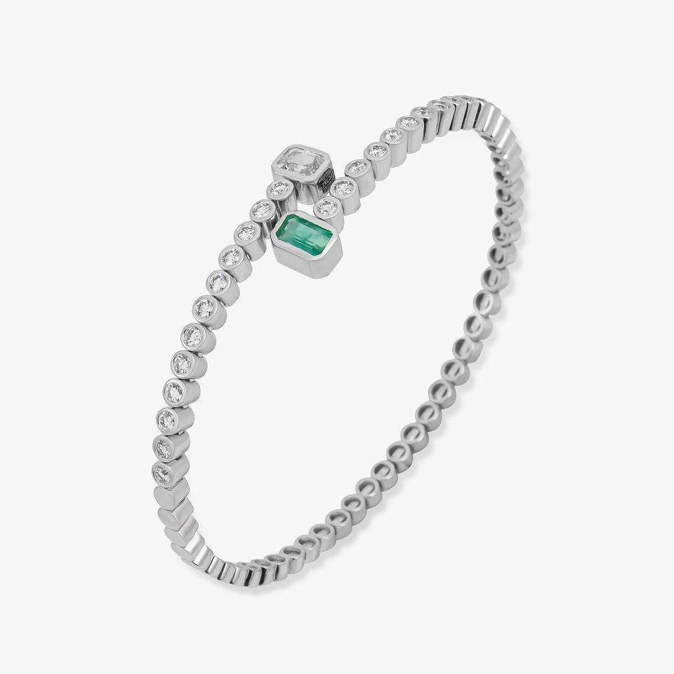 The Following Item we are offering are this Rare Important Radiant 14KT White Gold Gorgeous Glittering and Sparkling Magnificent Fancy Emerald and White Sapphire Bangle Bracelet. Bangle contains a Beautiful Rare Fancy Emerald and a Large White