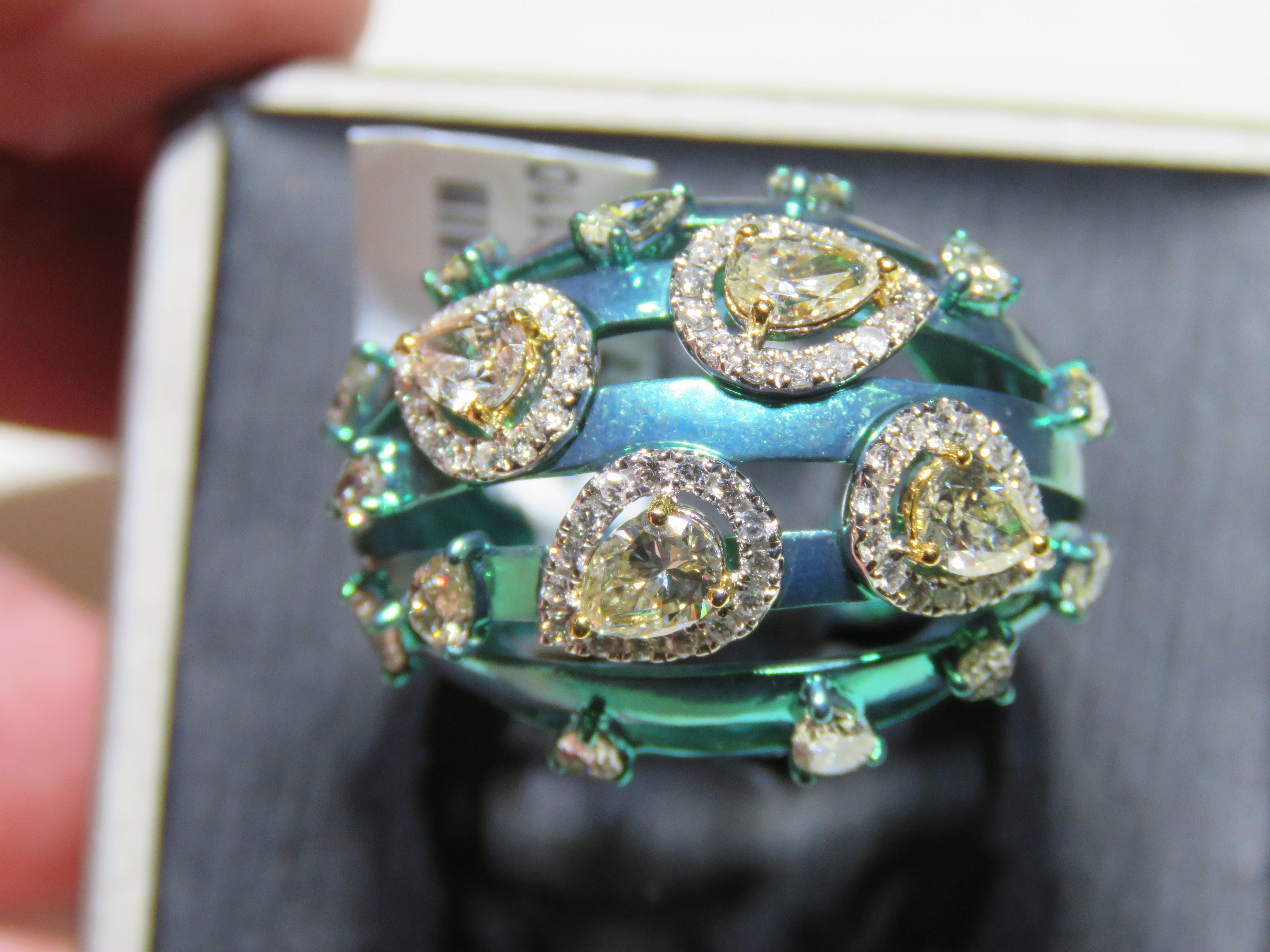 The Following Item we are offering is this Rare Important Radiant 18KT Gold and Titanium Gorgeous Glittering and Sparkling Magnificent Fancy Yellow Diamond Ring. Ring Contains approx 3CTS of Beautiful Fancy Cut Fancy Yellow Diamonds framed with