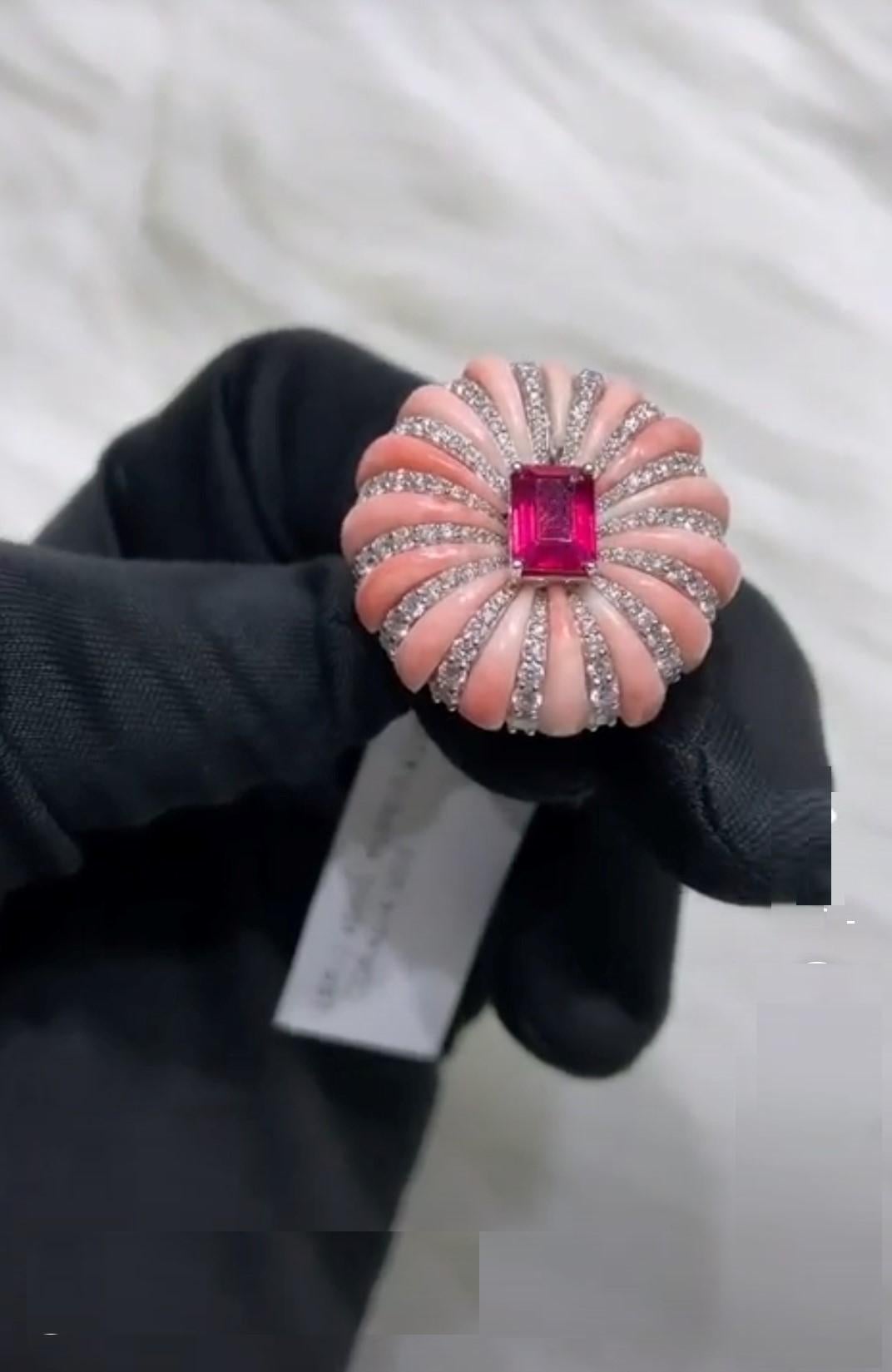 The Following Item we are offering is a Rare Important Radiant White Gold Large Fancy Coral Ruby Diamond Ring. Ring is comprised of A Gorgeous Fancy Fiery Ruby surrounded with Exquisite Rare Coral and  Glittering Diamonds T.C.W APPROX 9.50 CTS!!!