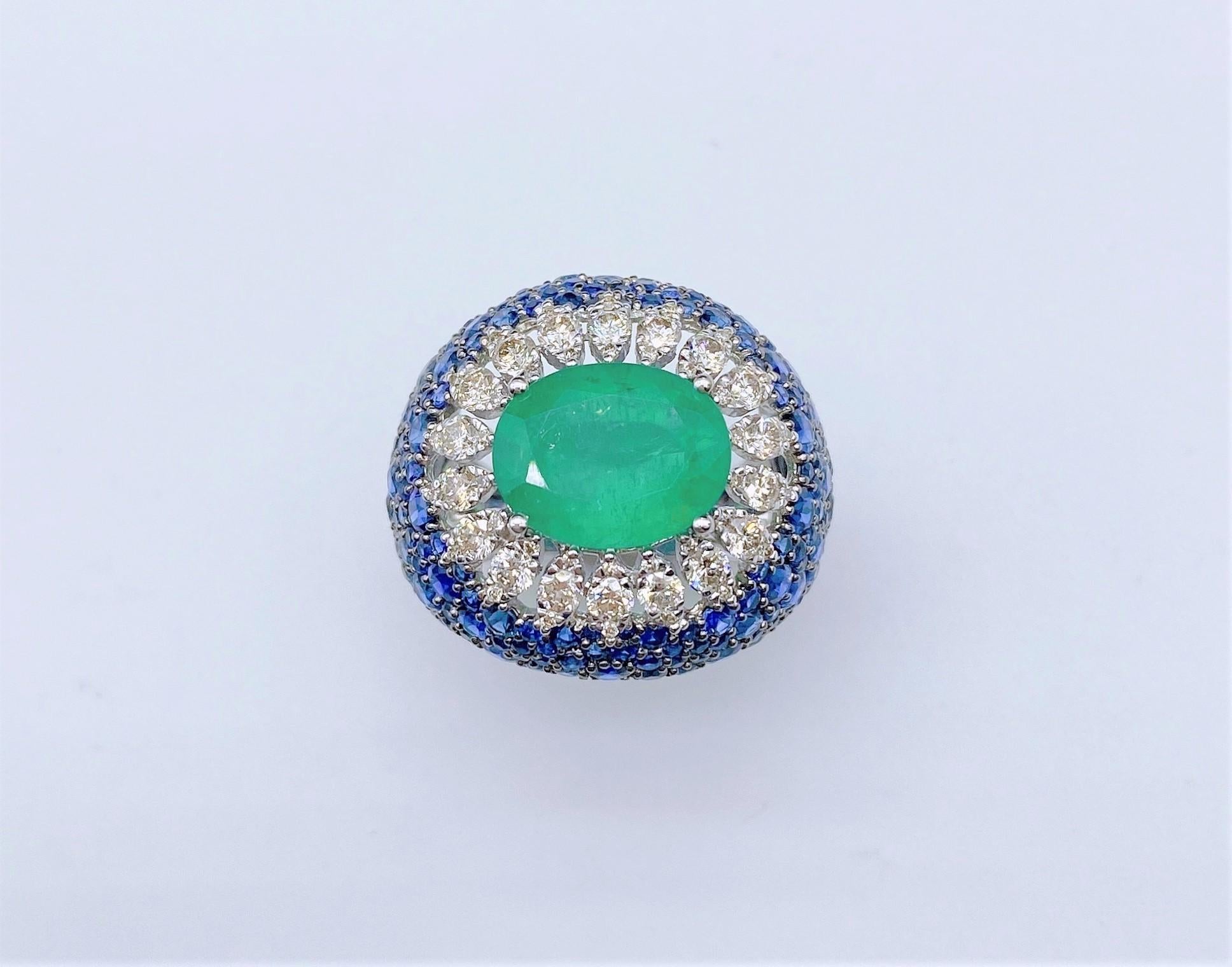 The Following Item we are offering is a Rare Important Radiant 18KT Gold Large Fancy Glittering Emerald, Blue Sapphire, and Diamond Ring. Ring is comprised of A LARGE Gorgeous Fancy Emerald sitting atop Beautiful Glittering Fancy Blue Sapphires