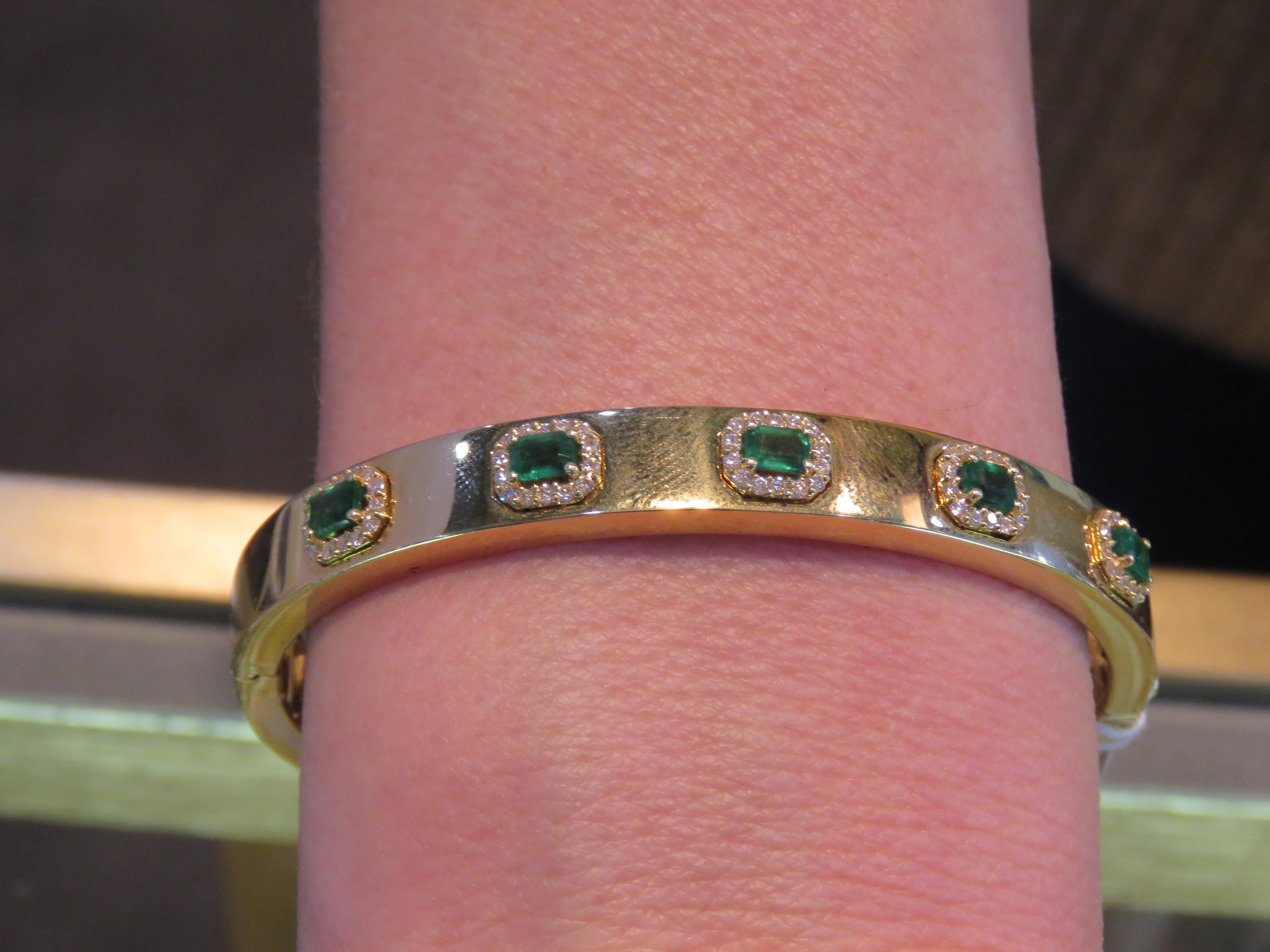 The Following Item we are offering is a Rare Magnificent Radiant 18KT Gold Large Rare Gorgeous Fancy Emerald and Diamond Bangle Bracelet. Bracelet is comprised of Beautiful Glittering Emeralds surrounded with Gorgeous Diamonds!!! T.C.W. Approx