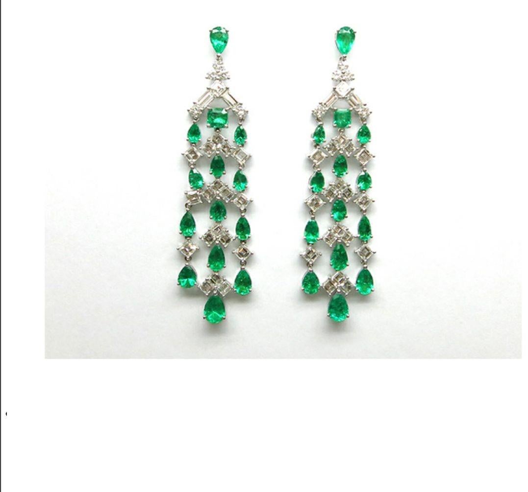 The Following Item we are offering is this Rare Important Radiant 18KT Gold Gorgeous Glittering and Sparkling Magnificent Fancy Colombian Emerald and Diamond Dangle Earrings. Earrings Contains approx 20CTS of Beautiful Fancy Cut Colombian Emeralds