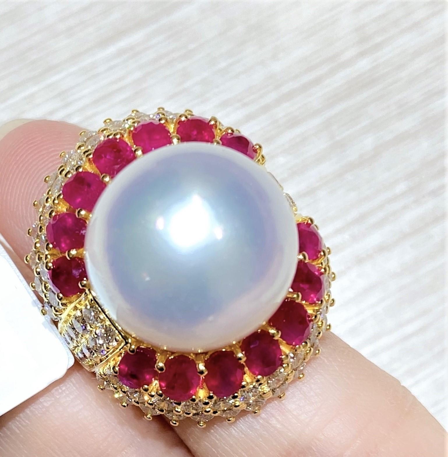 The Following Item we are offering is this Extremely Rare Beautiful 18KT Gold Fine Fancy Rare Large South Sea Pearl Ruby Diamond Ring. This Magnificent Ring is comprised of a Rare Fine Large South Sea Pearl and Round Gorgeous Glittering Fancy Rubies