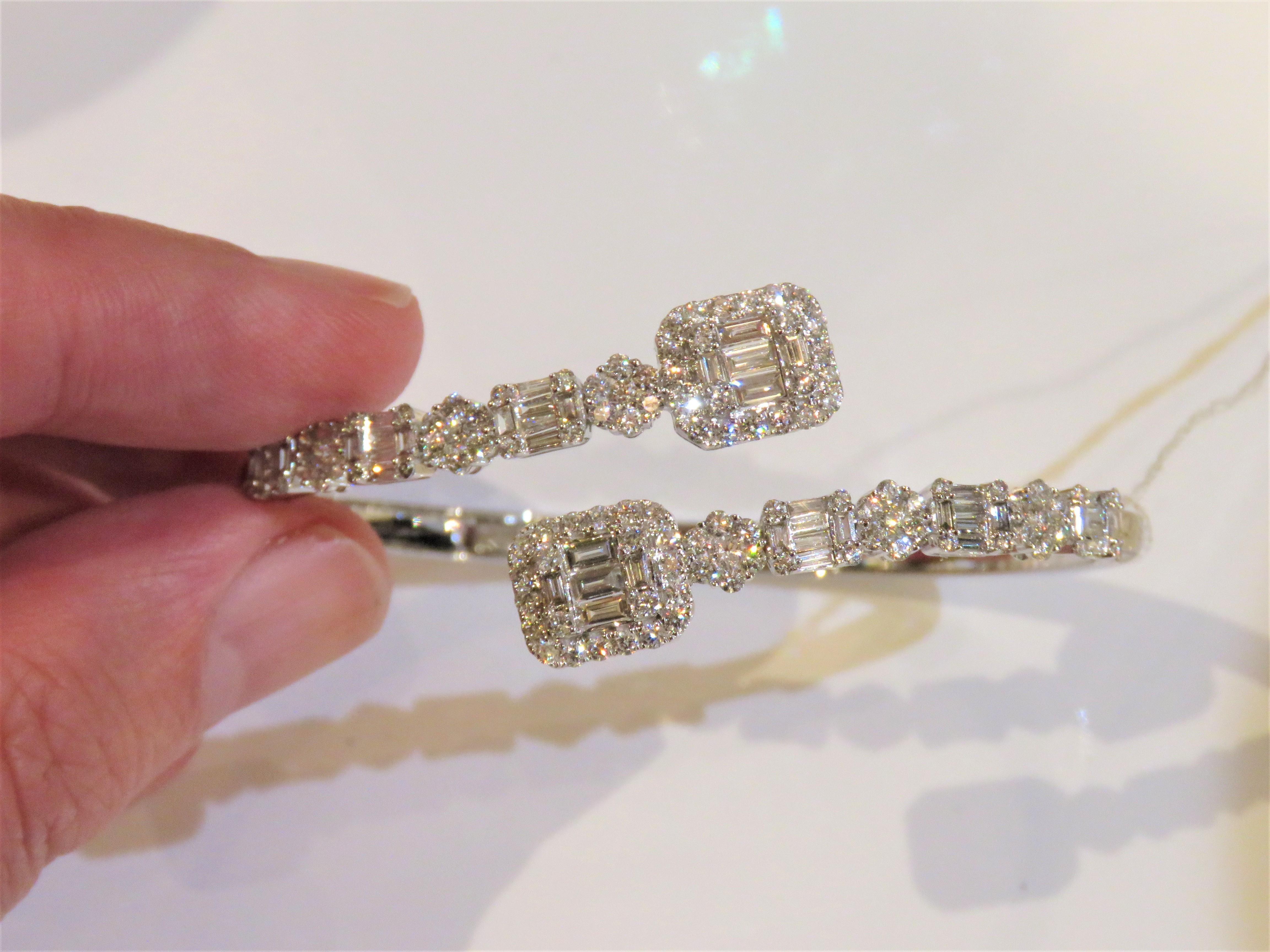 The Following Item we are offering is a Rare Important Radiant 18KT Gold Large Magnficent Rare Fancy Gorgeous Diamond Crossover Bangle Bracelet. Bangle is comprised of Exquisite Fancy Magnificent Baguette Cut and Round Diamonds!!! T.C.W. Approx