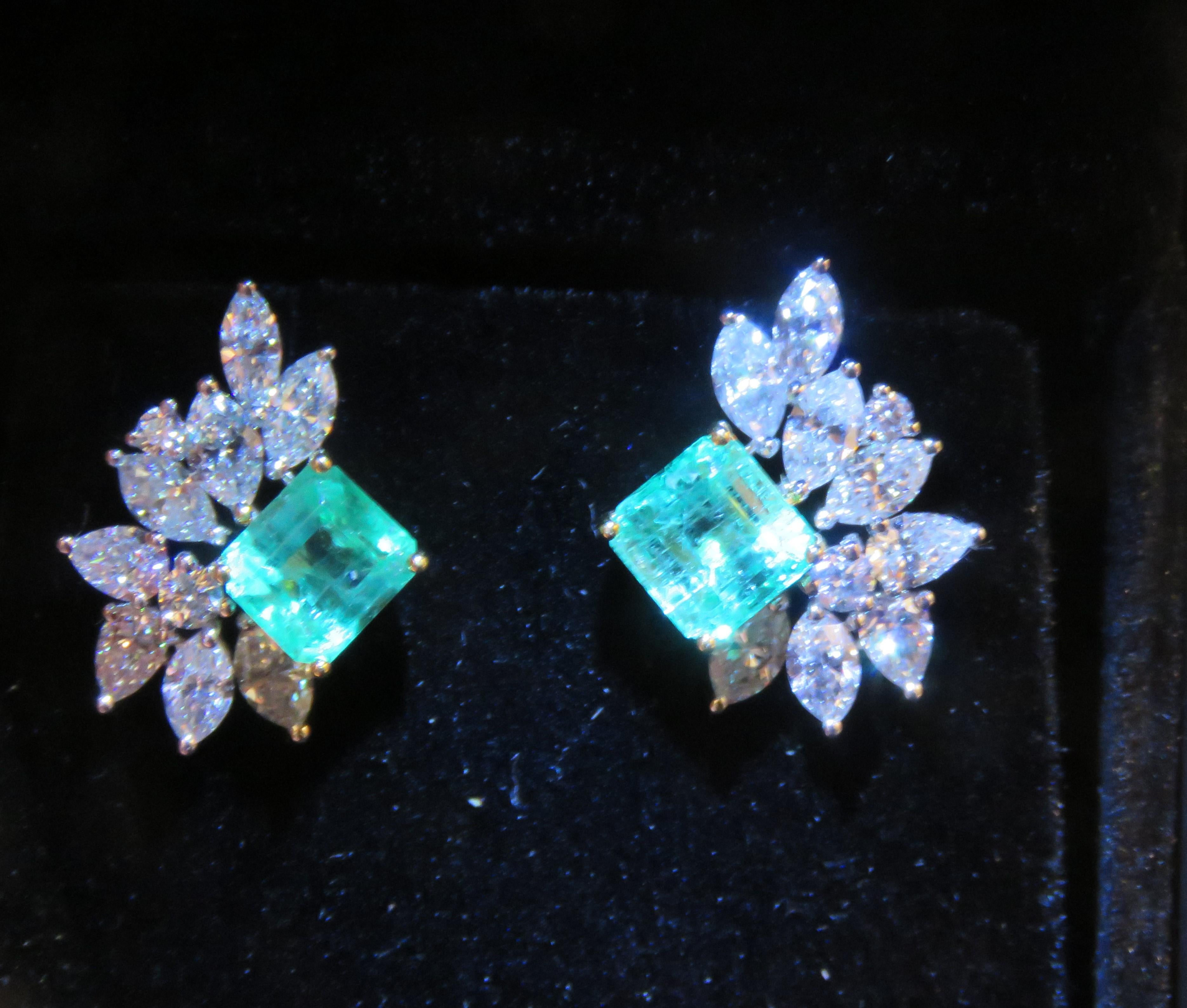 The Following Items we are offering is a Rare Important Radiant 18KT White Gold Elaborate Colombian Emerald and Diamond Earrings. Magnificent Rare Large Sparkling Emeralds Fancy Flanked by Fine Glittering Marquise Shaped Diamonds!! T.C.W. Approx