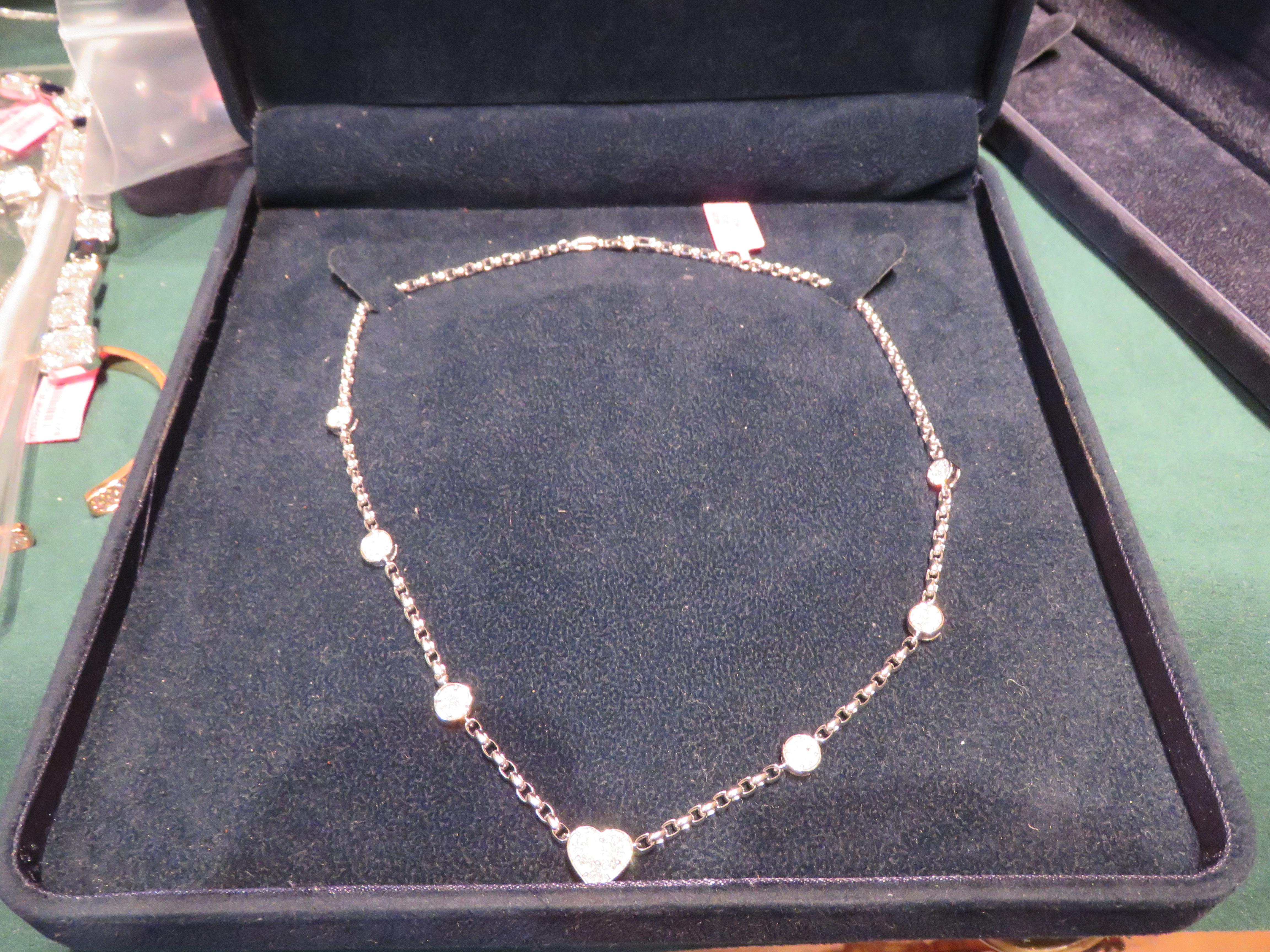A Rare 18KT White Gold Diamond Necklace. Necklace is comprised of Finely Set Glittering Gorgeous Heart Shaped Diamond Center and adorned with Round Diamonds!!! The Diamonds are of Exquisite and Fine Quality. T.C.W. Approx 1.50CTS!!! This Gorgeous