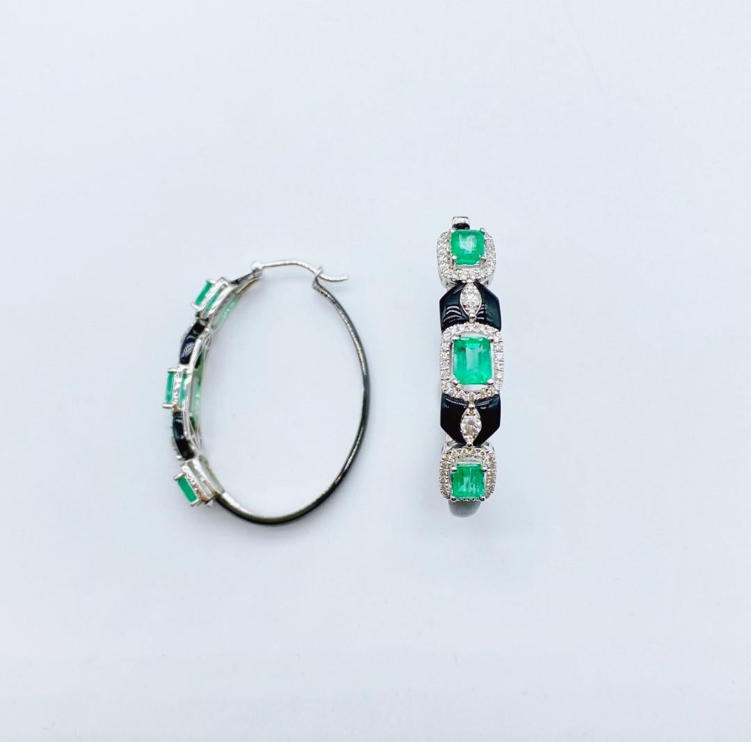 The Following Item we are offering is this Rare Important Radiant 18KT Gold Gorgeous Glittering and Sparkling Magnificent Fancy Green Emerald and Onyx Diamond Hoop Earrings. Earrings Contains approx 5.50CTS of Beautiful Fancy Cut Emeralds, Diamonds,