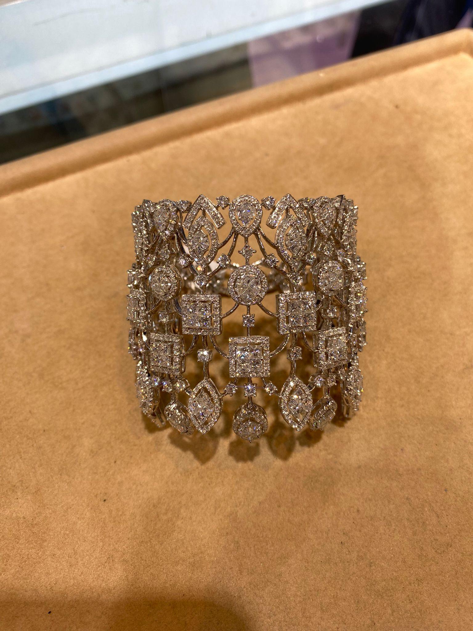 The Following Item we are offering is this Beautiful Rare Important 18KT Gold Sparkling Bracelet Cuff Bracelet FEATURES an Array of Magnificent Rare Assorted Gorgeous Fancy Baguette Cut Cluster Diamonds surrounded with Magnificent Round Diamonds.