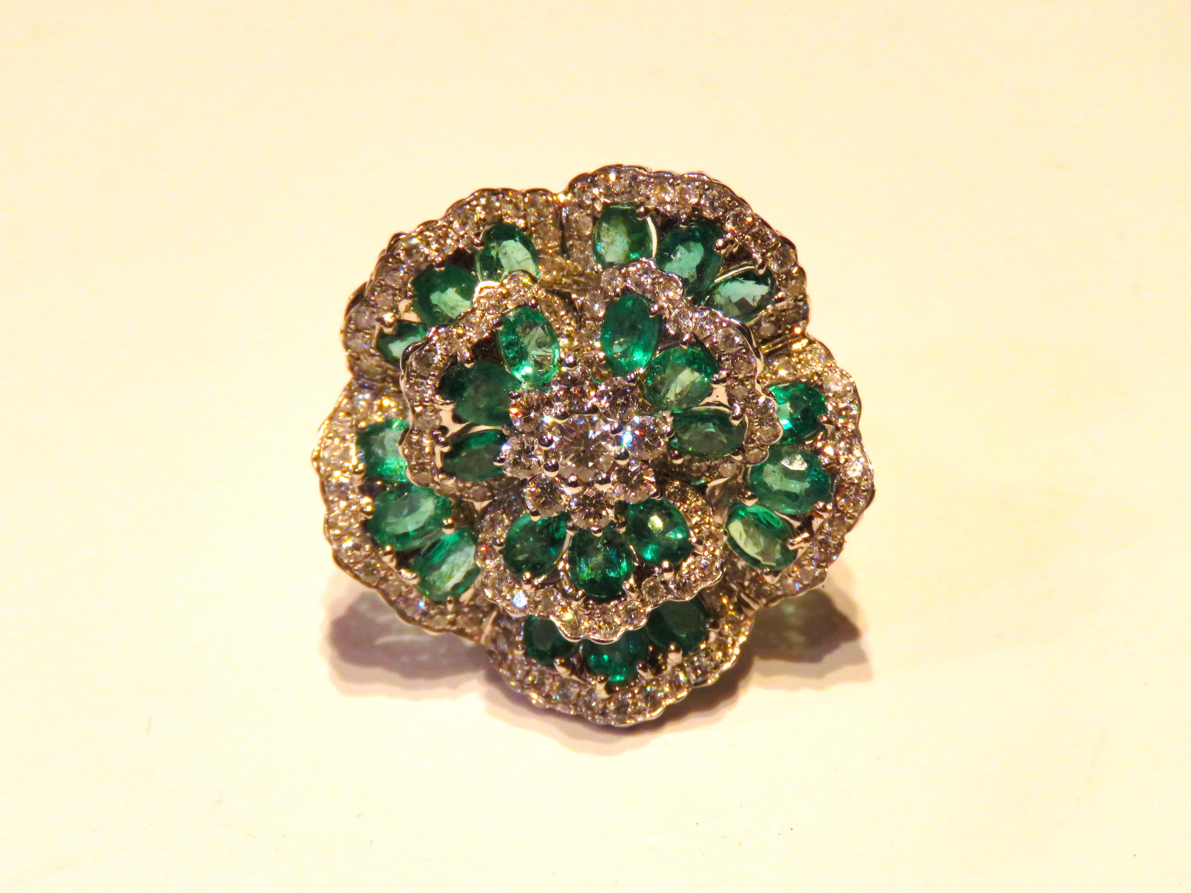 The Following Item we are offering is a Rare Important Radiant 18KT Gold Large Fancy Large Emerald and Diamond Flower Floral Ring. Ring is comprised of Gorgeous Fancy Shimmering Emeralds surrounded with Beautiful Glittering Fancy Diamonds. T.C.W