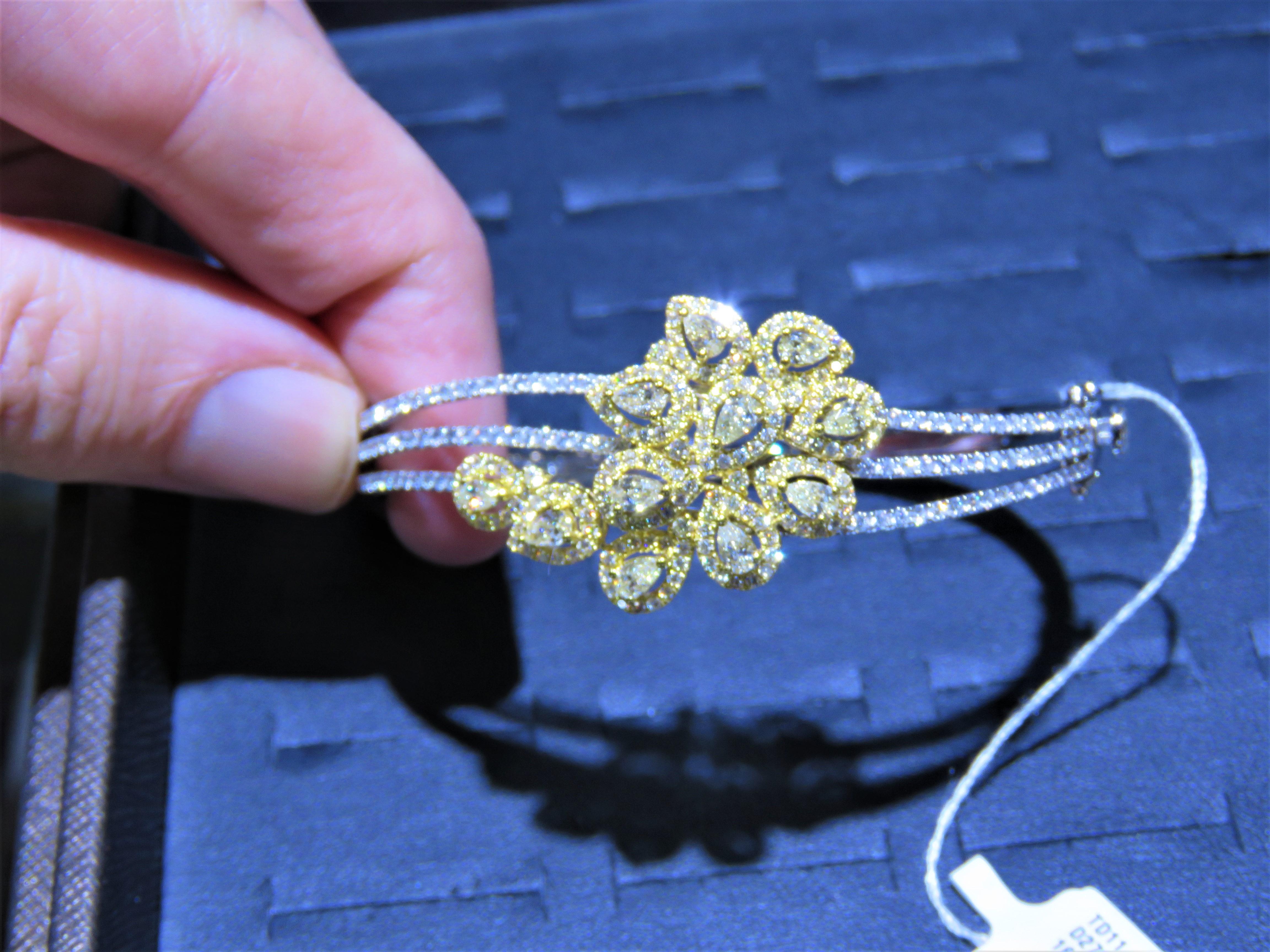 The Following Item we are offering is this Extremely Rare Beautiful 18KT Gold Fine Rare Large Triple Row Fancy Yellow Diamond Cluster Bangle Bracelet. This Magnificent Bangle is comprised of Rare Fine Fancy Yellow Diamonds with White Diamonds!!!