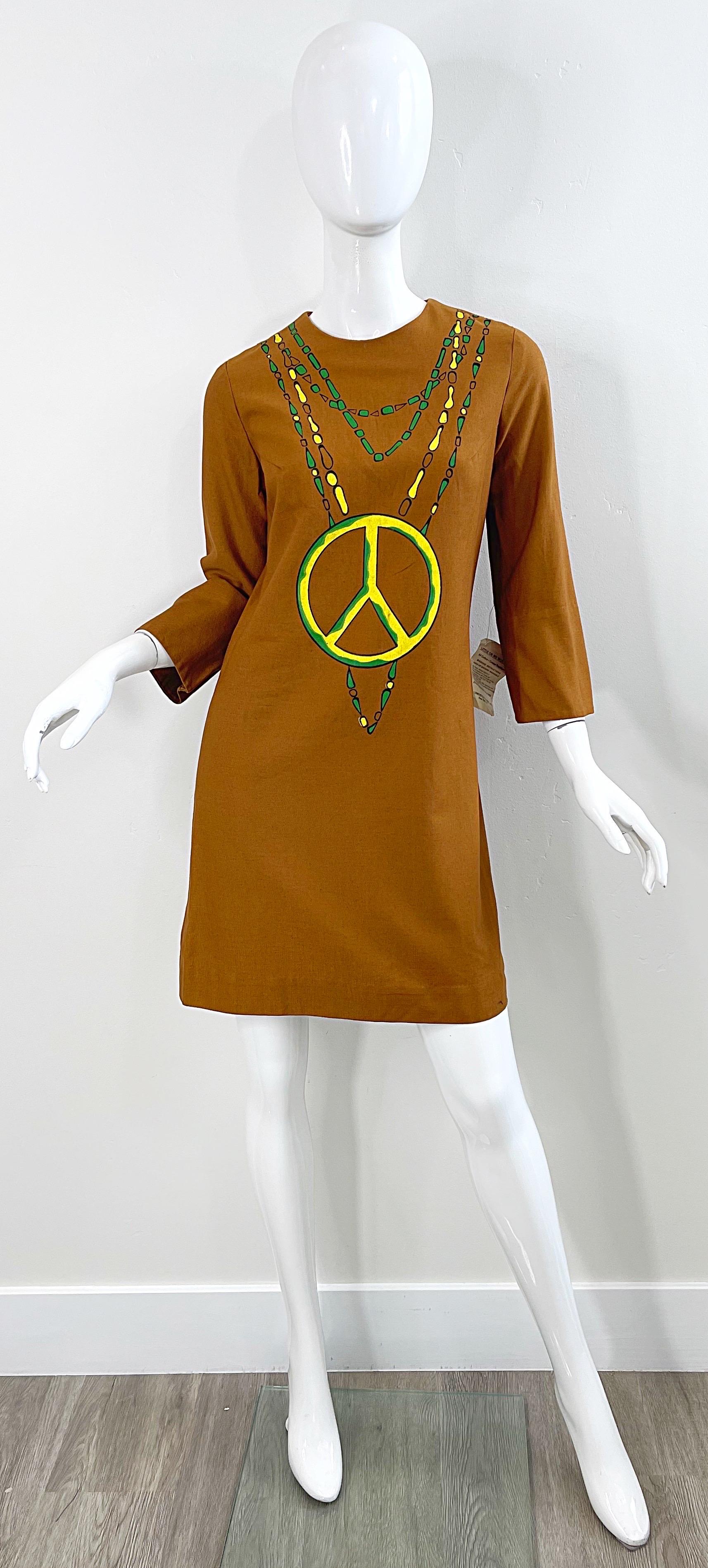 Deadstock chic hand painted peace sign cotton shift dress ! Features brown terracotta color, painted with green and yellow. Hidden metal zipper up the back with hook-and-eye closure. Perfect for any day or evening event. Pair with wedges, sandals or