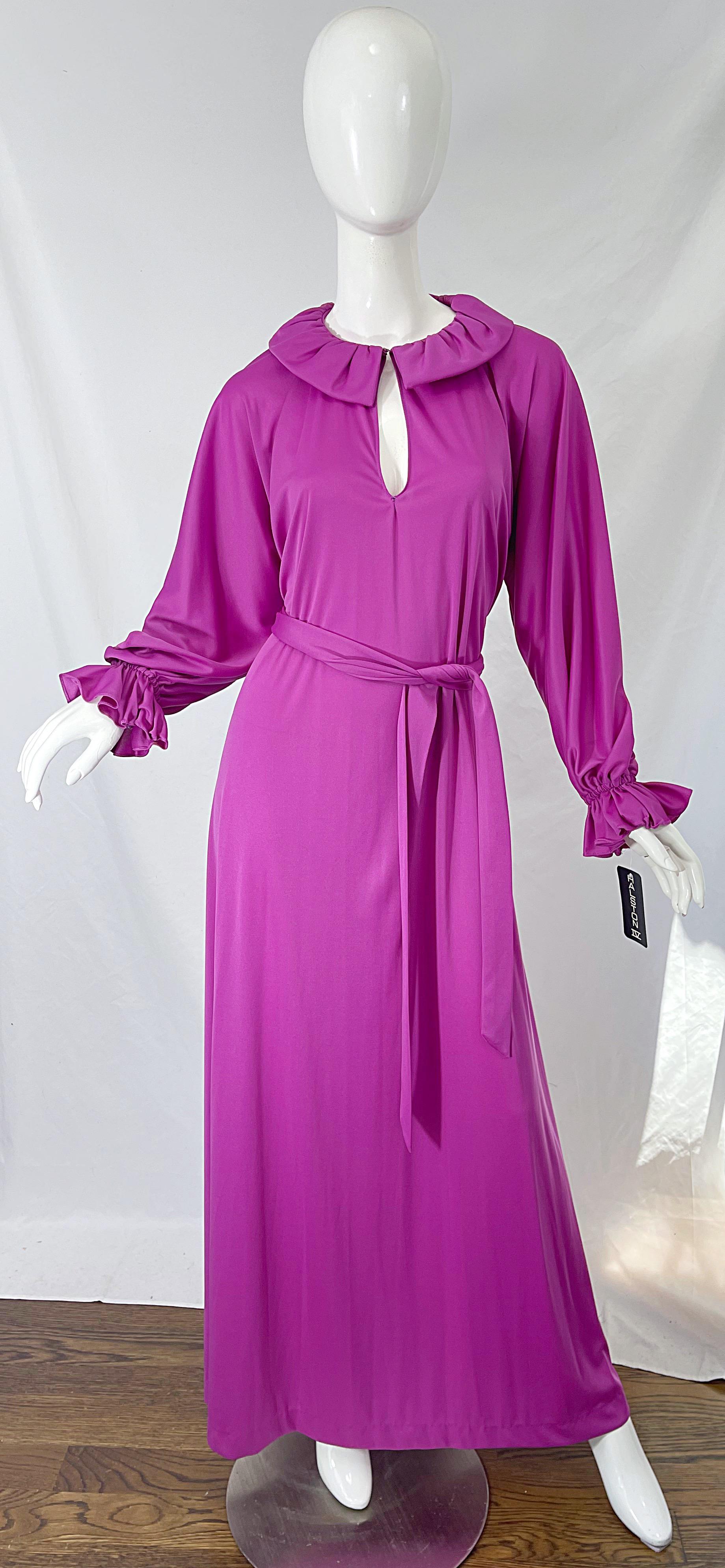 Deadstock (new with original store tags attached) 1970s HALSTON IV purple/pink long sleeve maxi dress ! Features a slinky jersey with a matching tie belt. Hook-and-eye closure at center neck. 
In great unworn condition with store tags still