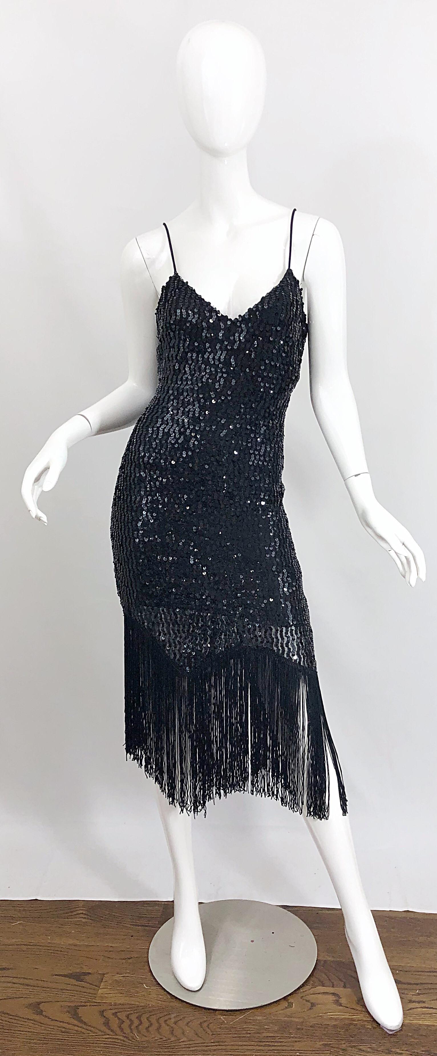 New with tags 70s does 20s JOY STEVENS black sequined flapper style fringed dress! Features thousands of hand-sewn black sequins throughout. Fringe hem makes this dress perfect for dancing. Figure flattering fit that features some stretch. Hidden