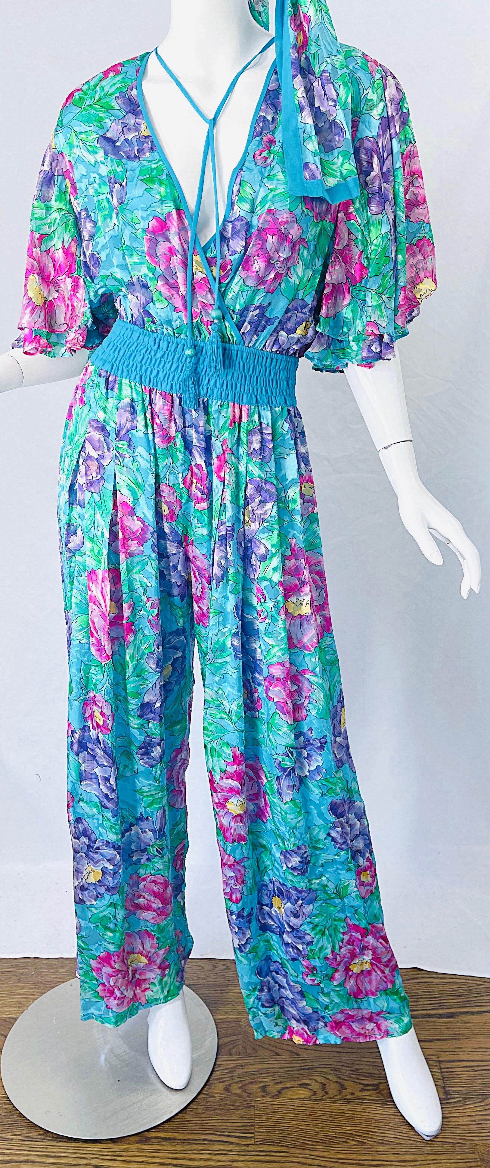 Chic and stylish brand new never worn with tags / deadstock DIANE FREIS mid 1980s silk and rayon wide leg  jumpsuit ! Features a luxurious silk blend flower printed fabric in teal, green, blue, pink, purple, yellow and white throughout. Tassels at