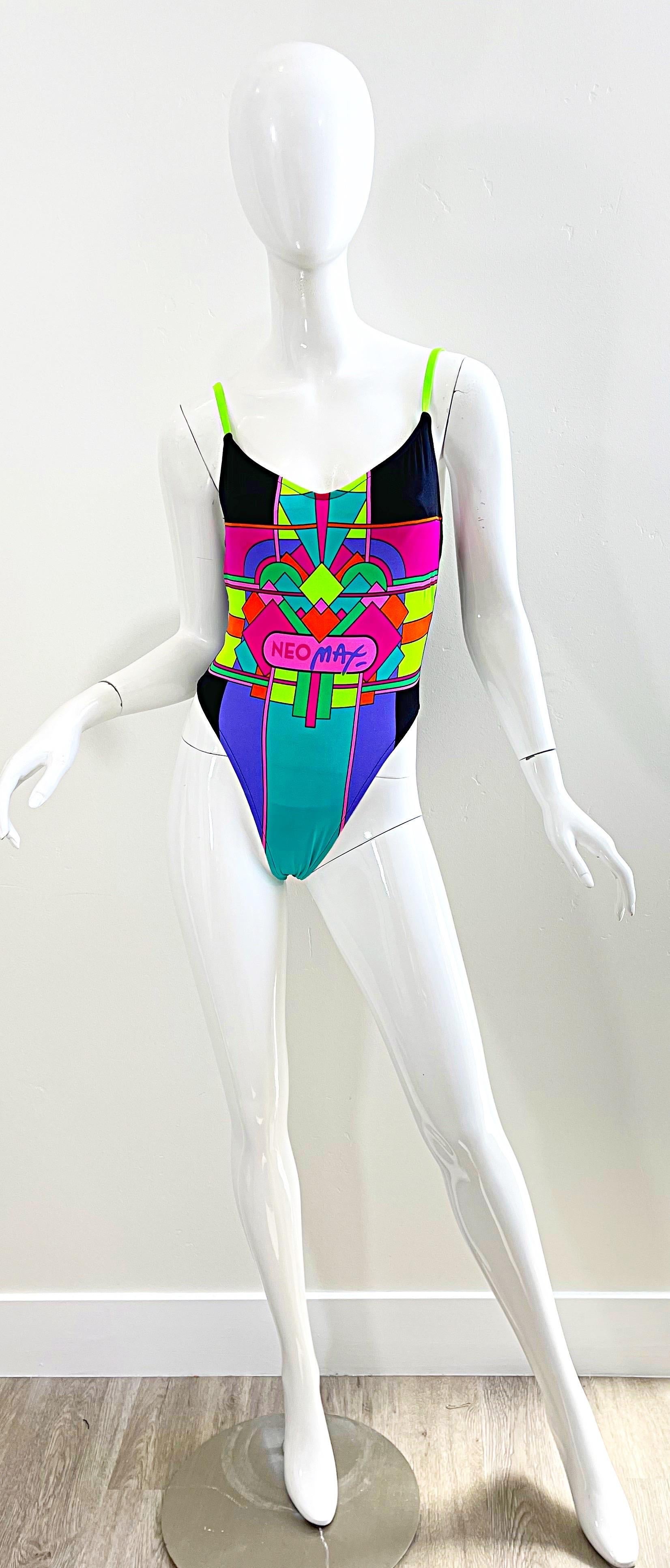 Awesome brand new deadstock 80s PETER MAX Neomax one piece abstract art print neon swimsuit or bodysuit ! Features vibrant neon colors of pink, green, highlighter yellow, turquoise, and purple throughout. Sexy plunging back. Simply slips over the