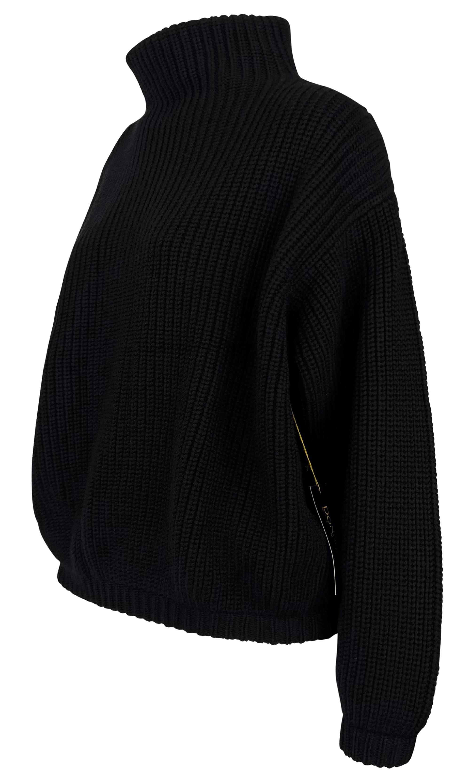 This black Donna Karan sweater from the 1990s is new with tags and features an oversized silhouette, a mock neck, and a chunky ribbed knit.

Approximate measurements:
Size - Petite
Shoulder to hem: 23