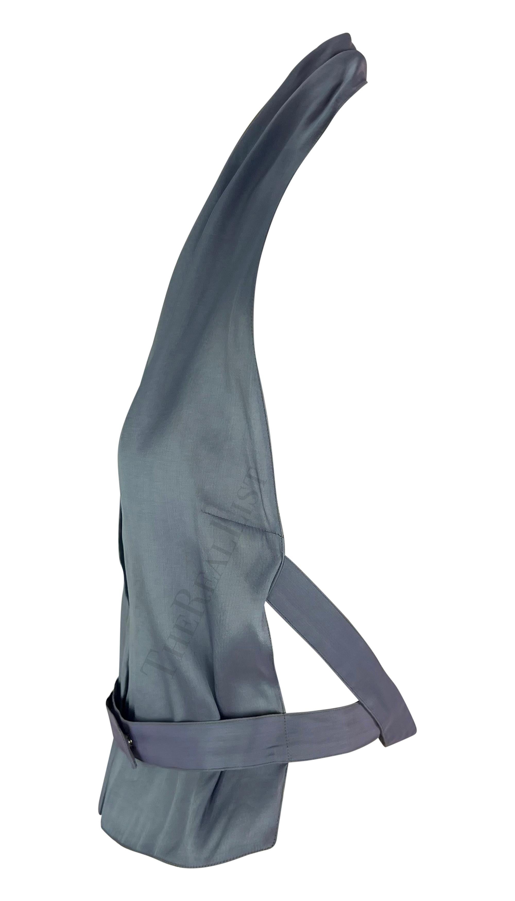 TheRealList presents: a chic light blue silk Giorgio Armani halterneck top. From the late 1990s, this top is constructed entirely of lightweight blue silk. The top features a snap button closure at the front, an exposed back, and straps that wrap
