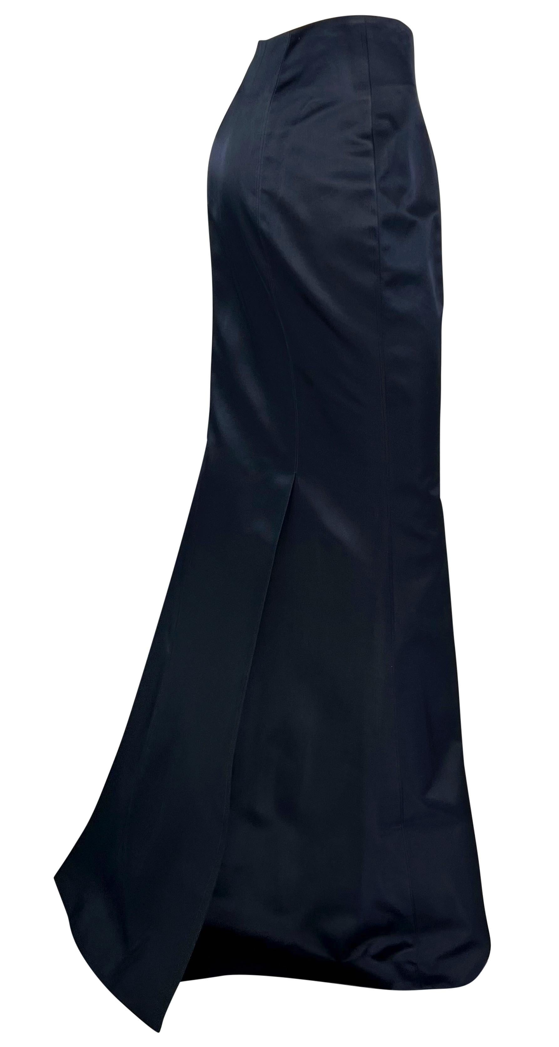 From the 1990s, this Richard Tyler navy blue satin maxi skirt epitomizes classic luxury. Constructed entirely of silk satin, this fabulous floor-length skirt features a flared hem and a small train. Never worn, with the original department store tag