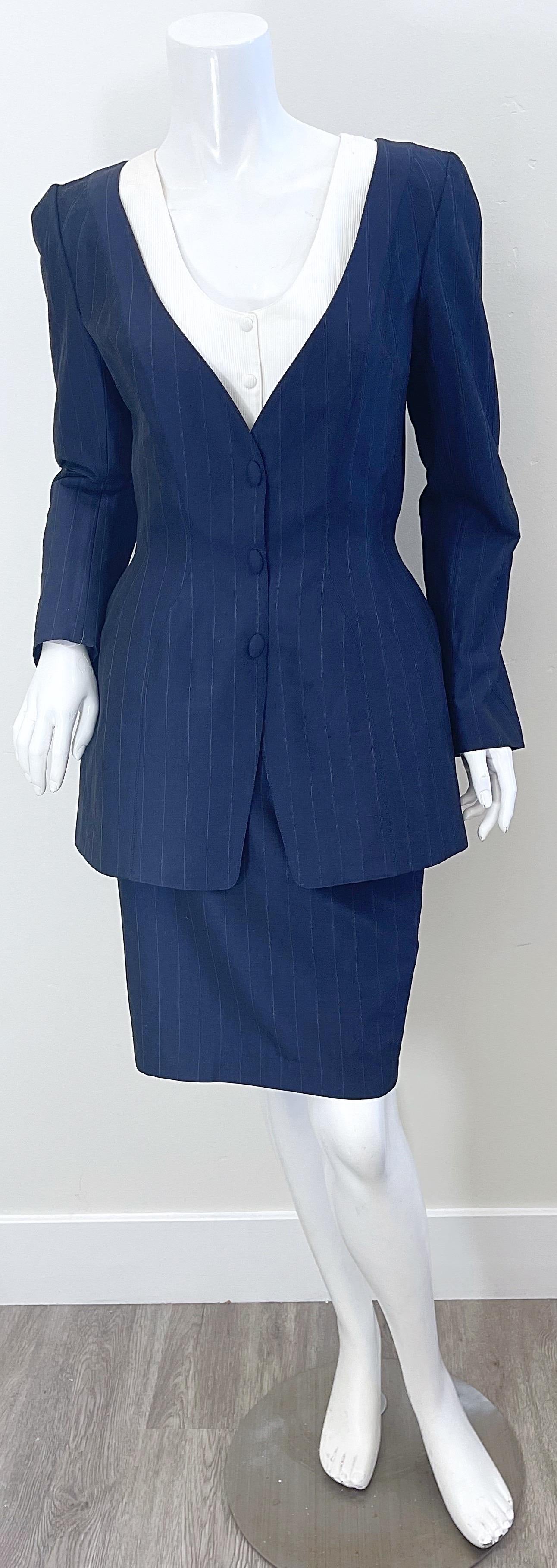 Chic brand new with original store tags early 90s THIERRY MUGLER navy blue and white pinstriped skirt suit ! This power suit features a tailored blazer features mock buttons with hidden snaps up the front. High waisted pencil skirt has hidden zipper