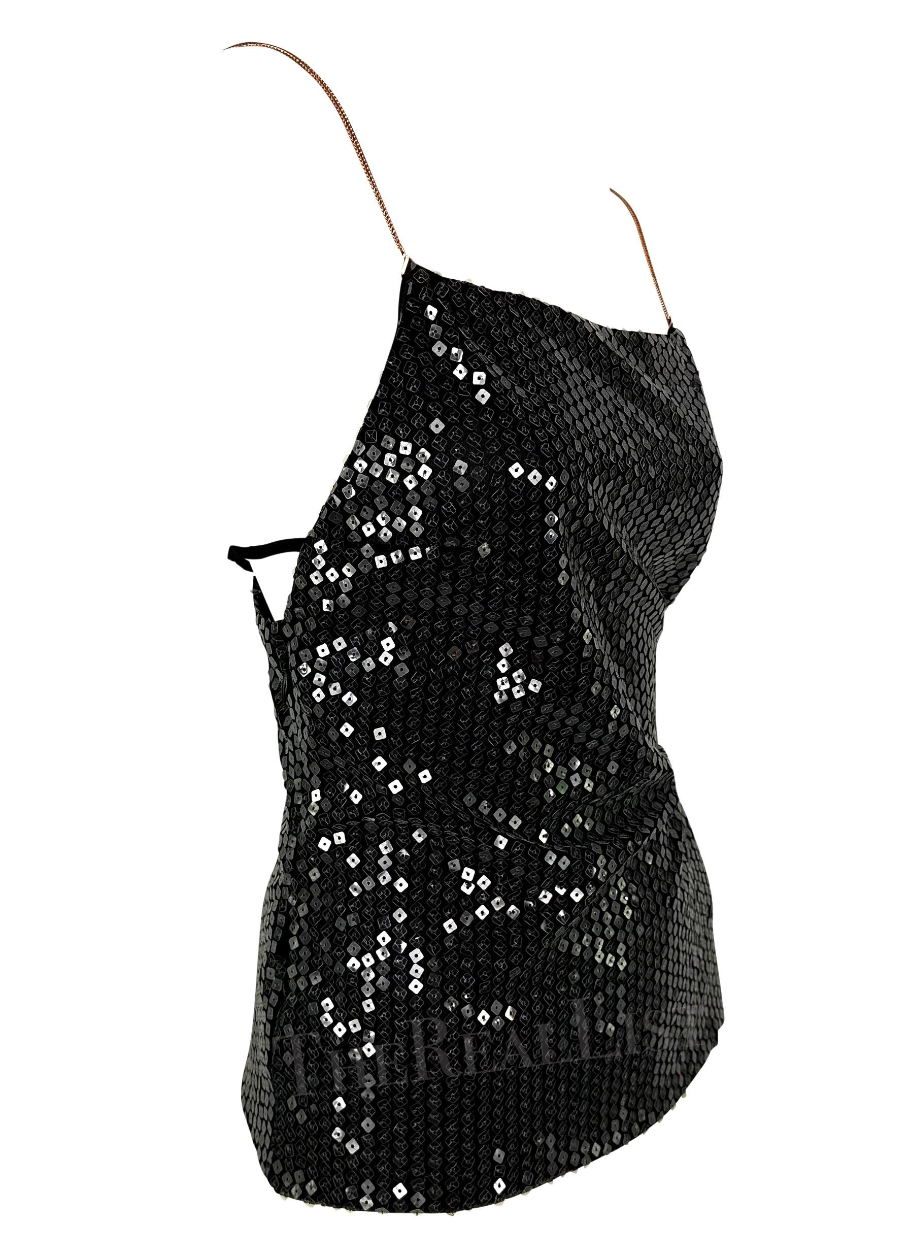 Presenting a fabulous black rhinestone Gianni Versace tank top, designed by Donatella Versace. From 1999, this top is covered in transparent sequins that perfectly catch the light with every movement. The top features a square neckline, and metal