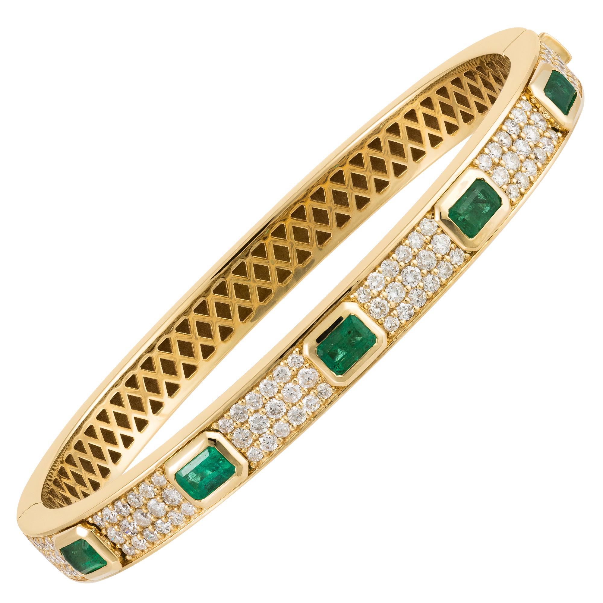 The Following Item we are offering is a Rare Magnificent Radiant 18KT Gold Large Rare Gorgeous Fancy Emerald and Diamond Bangle Bracelet. Bracelet is comprised of Beautiful Glittering Emeralds and a Triple Row of Gorgeous Diamonds!!! T.C.W. Approx