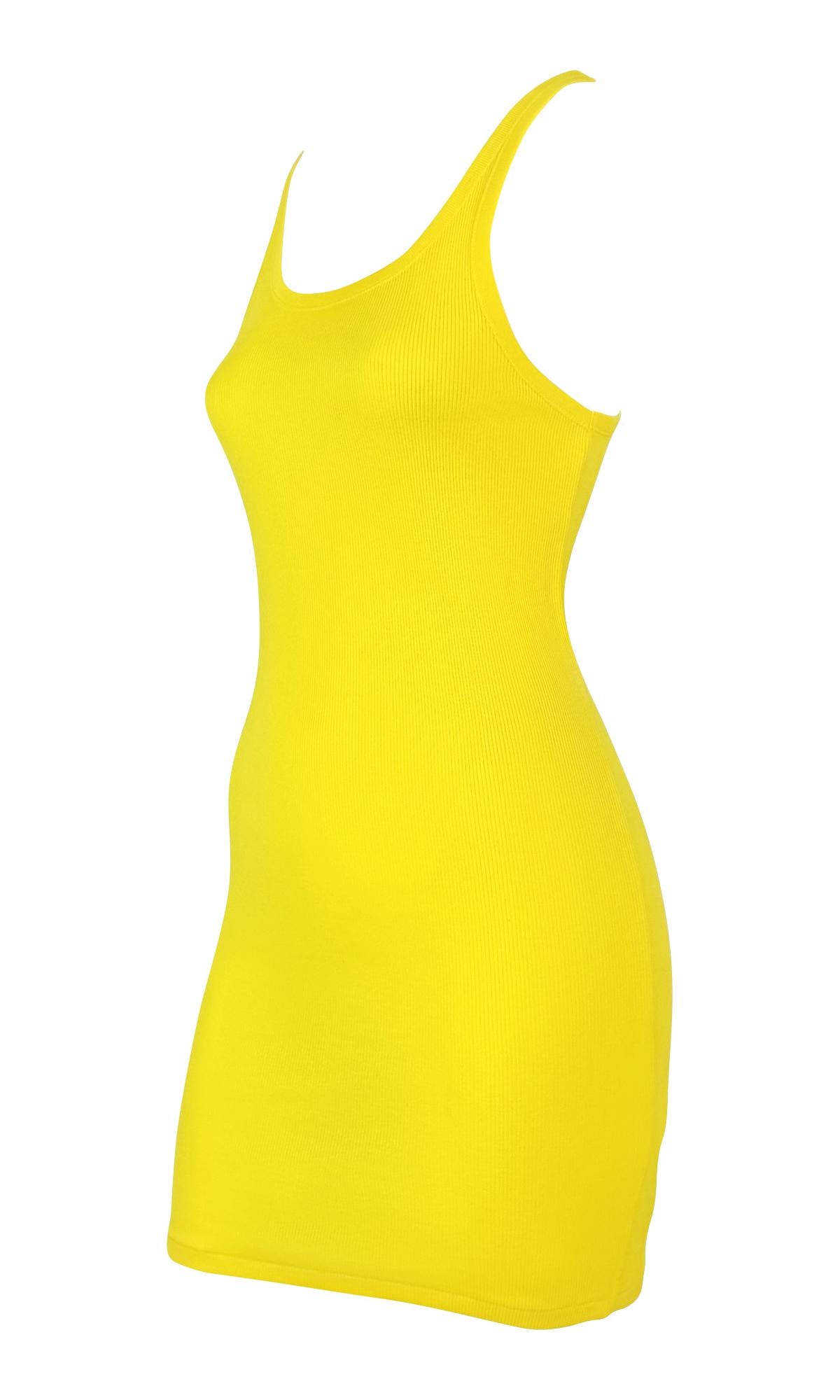This Ralph Lauren bright yellow tank dress from the 2000's is crafted from a soft ribbed knit cotton and features a minimal body sculpting silhouette. The design is complete with a scoop neckline and thin straps. Included original store tags still