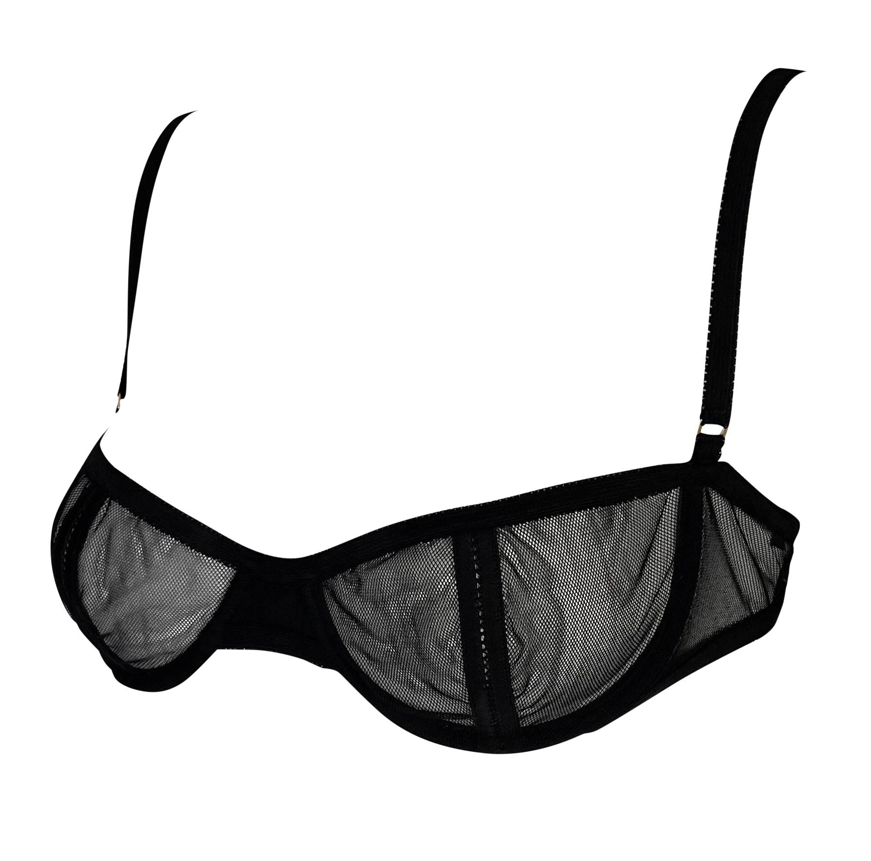 Designed by Tom Ford in 2003, this chic black Gucci mesh bra features cutout stripes on each cup. Never worn and complete with the original tags still attached, this sultry piece is a striking addition to any collection.

Approximate