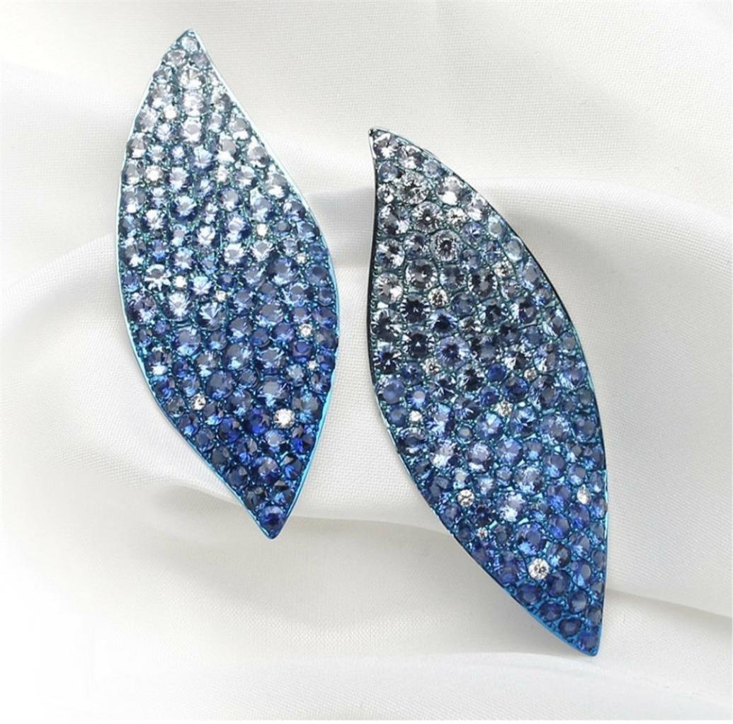 The Following Item we are offering is a Rare Important Radiant 18KT Gold Large Rare Fancy Blue Sapphire Diamond Cluster Leaf Earrings set in Platinum Rhodium!! Earrings are comprised of Gorgeous Assorted Blue Sapphires and Diamonds Spectacularly Set