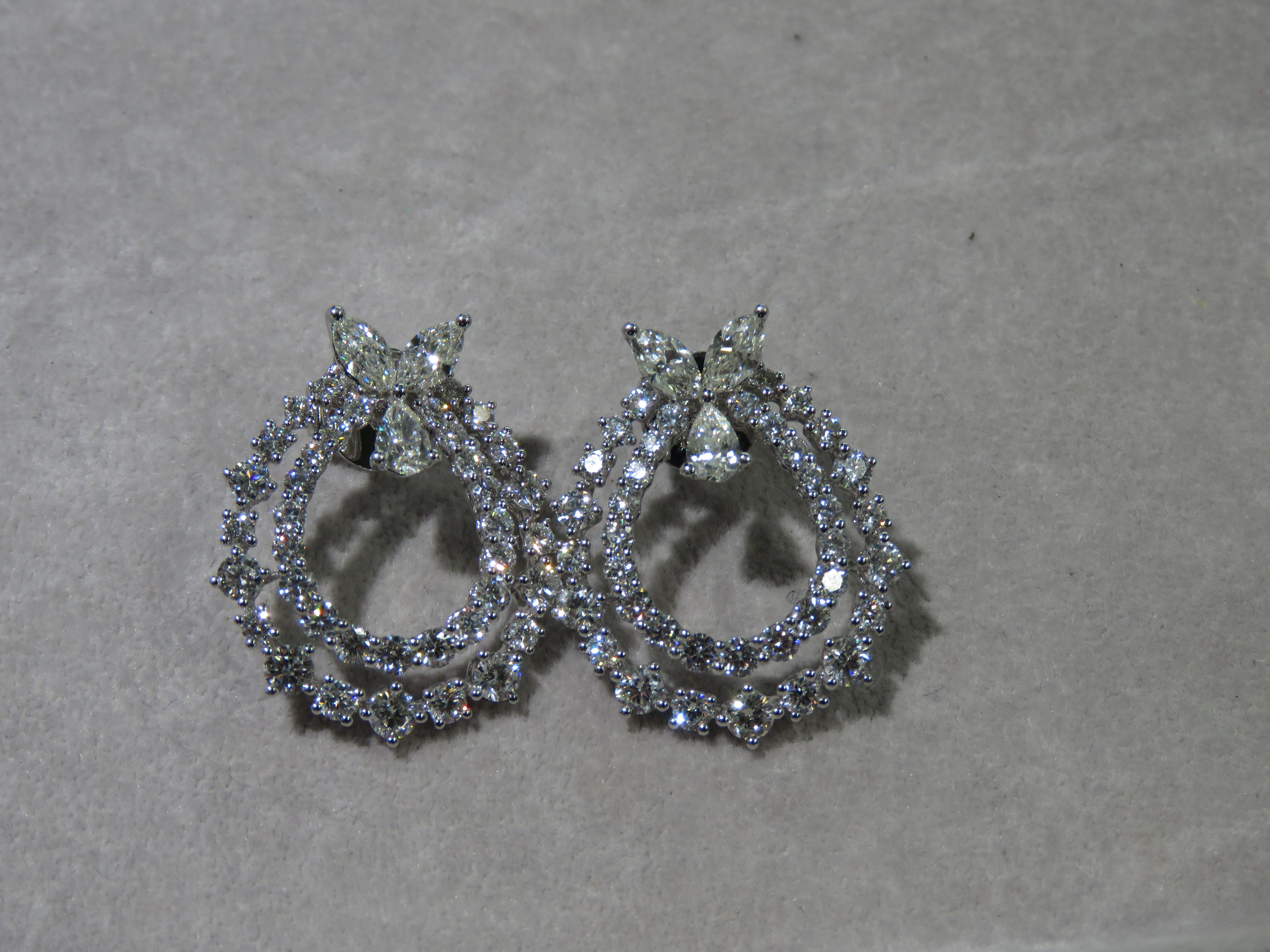 The Following Items we are offering is a Rare Important Radiant 18KT Gold Glamorous and Elaborate Rare Magnificent Glittering White Diamond Circular Round Bow Earrings. Earrings feature Rare Sparkling White Diamonds set in 18KT Gold!! T.C.W. Approx