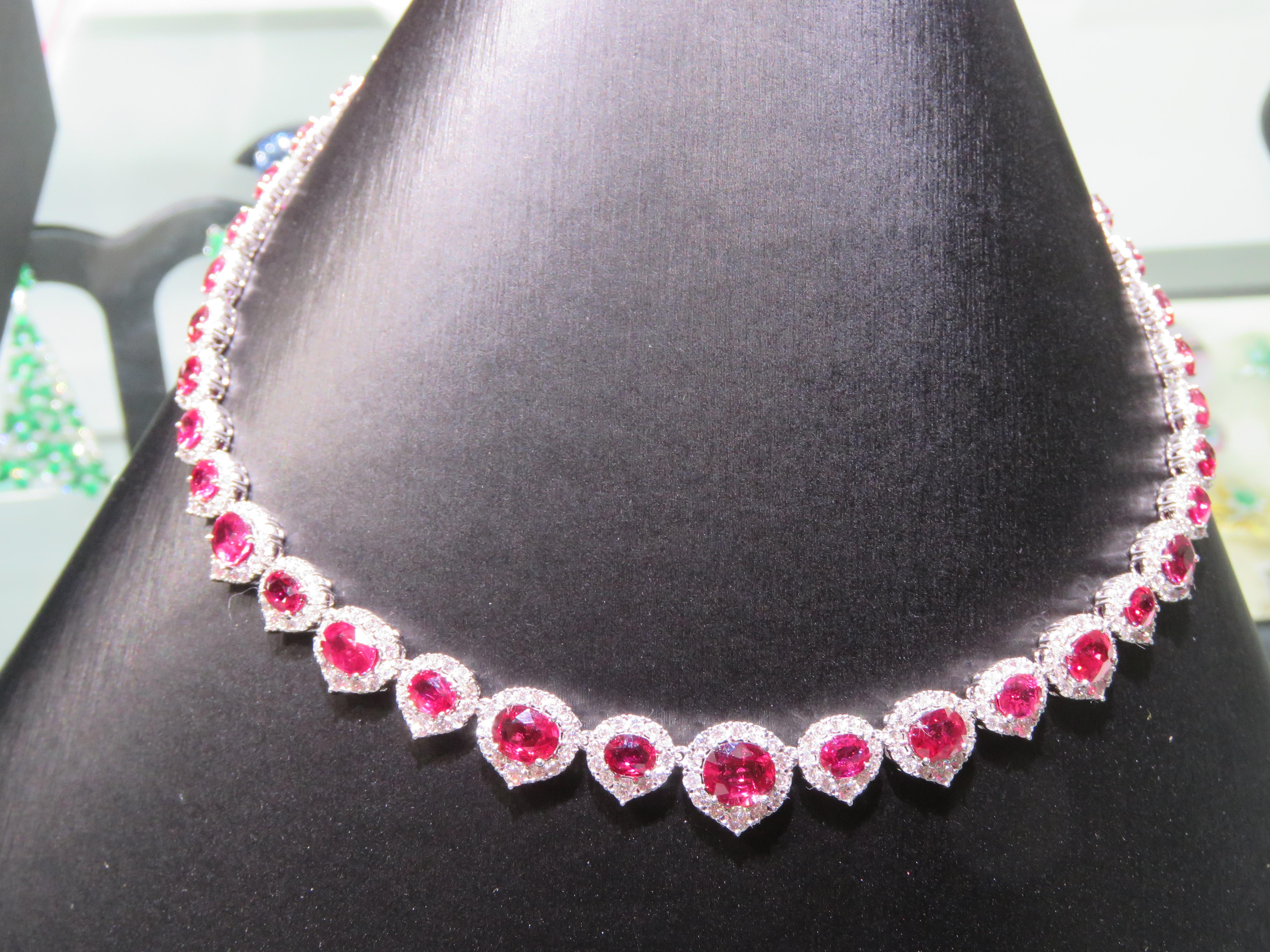 The Following Items we are offering is a Rare Important Radiant 18KT White Gold Necklace consisting of Fancy Oval Shaped Glittering Rubies and surrounded with Magnificent Diamonds Throughout. Features Large Certified Faceted Rubies interlocked