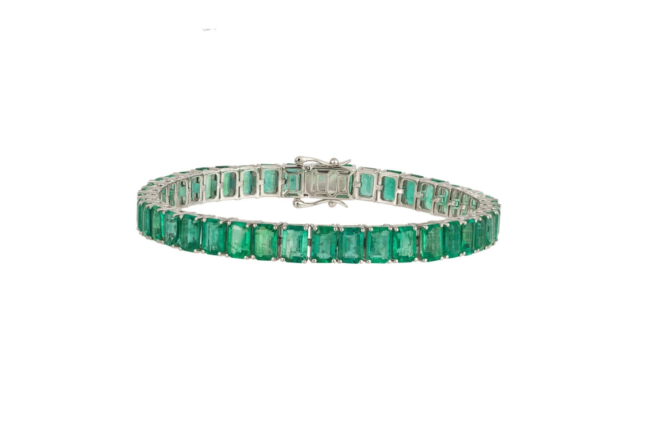 The Following Item we are offering is this Rare Important Radiant 18KT Gold Gorgeous Glittering and Sparkling Magnificent Fancy Emerald Cut Emerald Tennis Bracelet. Bracelet Contains approx 24CTS of Beautiful Fancy Green Emerald Cut Emeralds set in
