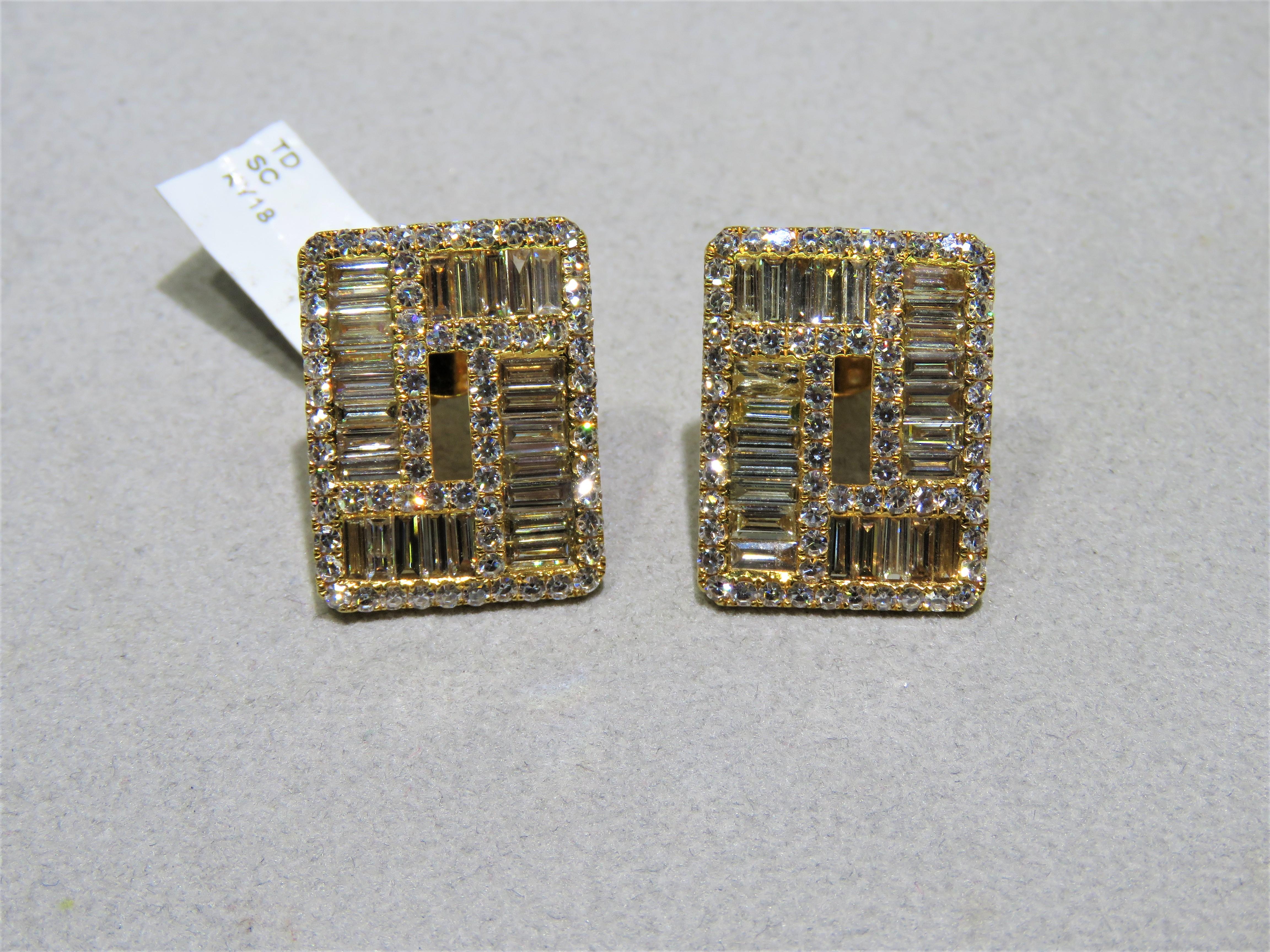 The Following Item we are offering are these Extremely Rare Beautiful 18KT Yellow Gold Fine Large Fancy Baguette Cut Trillion White Diamond Earrings. Each Earring features Rare Gorgeous Glittering Fancy Large Baguette Diamonds adorned with Sparkling