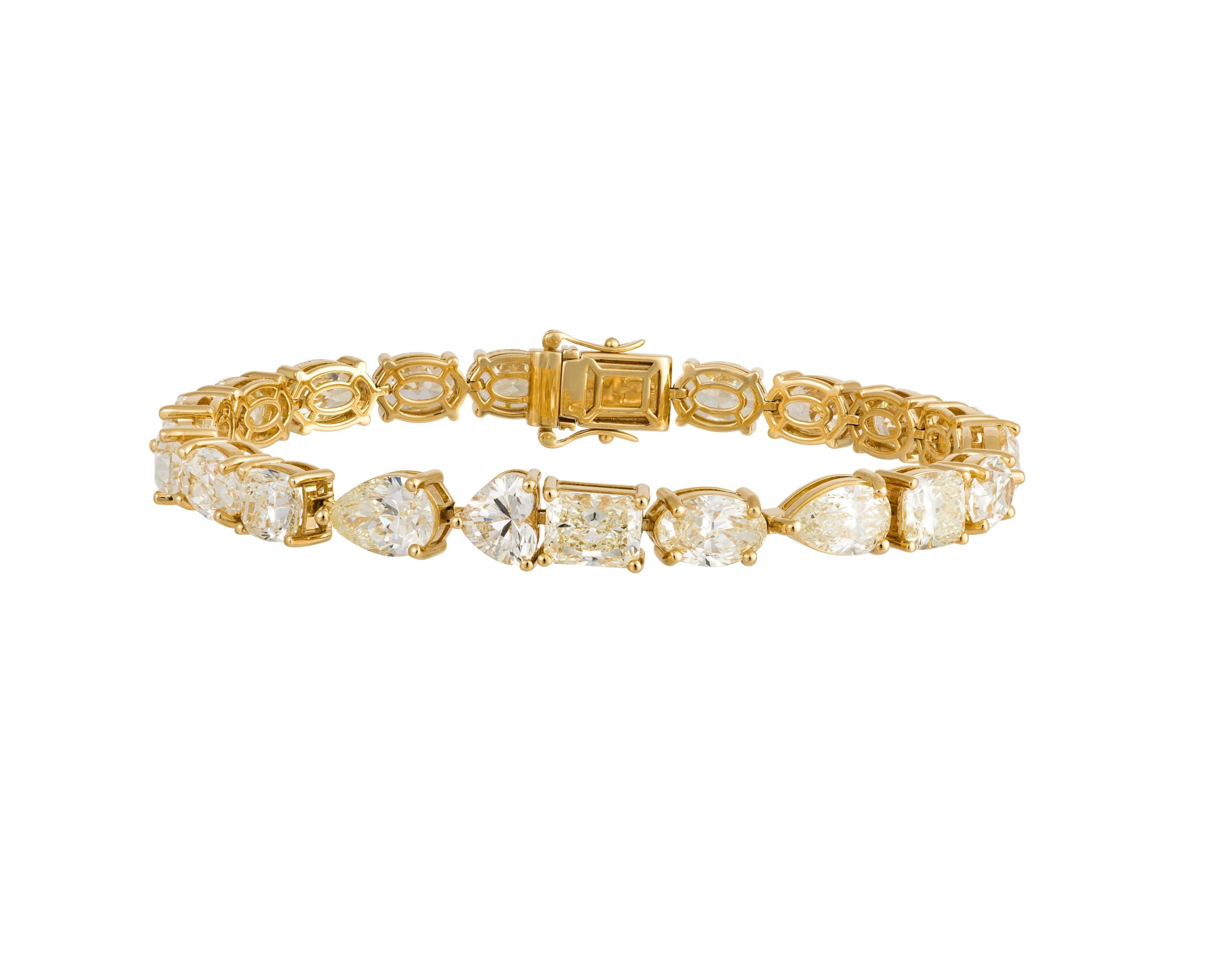 The Following Item we are offering is this Beautiful Rare Important 18KT Yellow Gold Large Glittering Fancy Cut Yellow Diamond Tennis Bracelet. Bracelet is comprised of over 23CTS Magnificent Rare Gorgeous Fancy Oval, Heart, Pear, & Emerald Cut