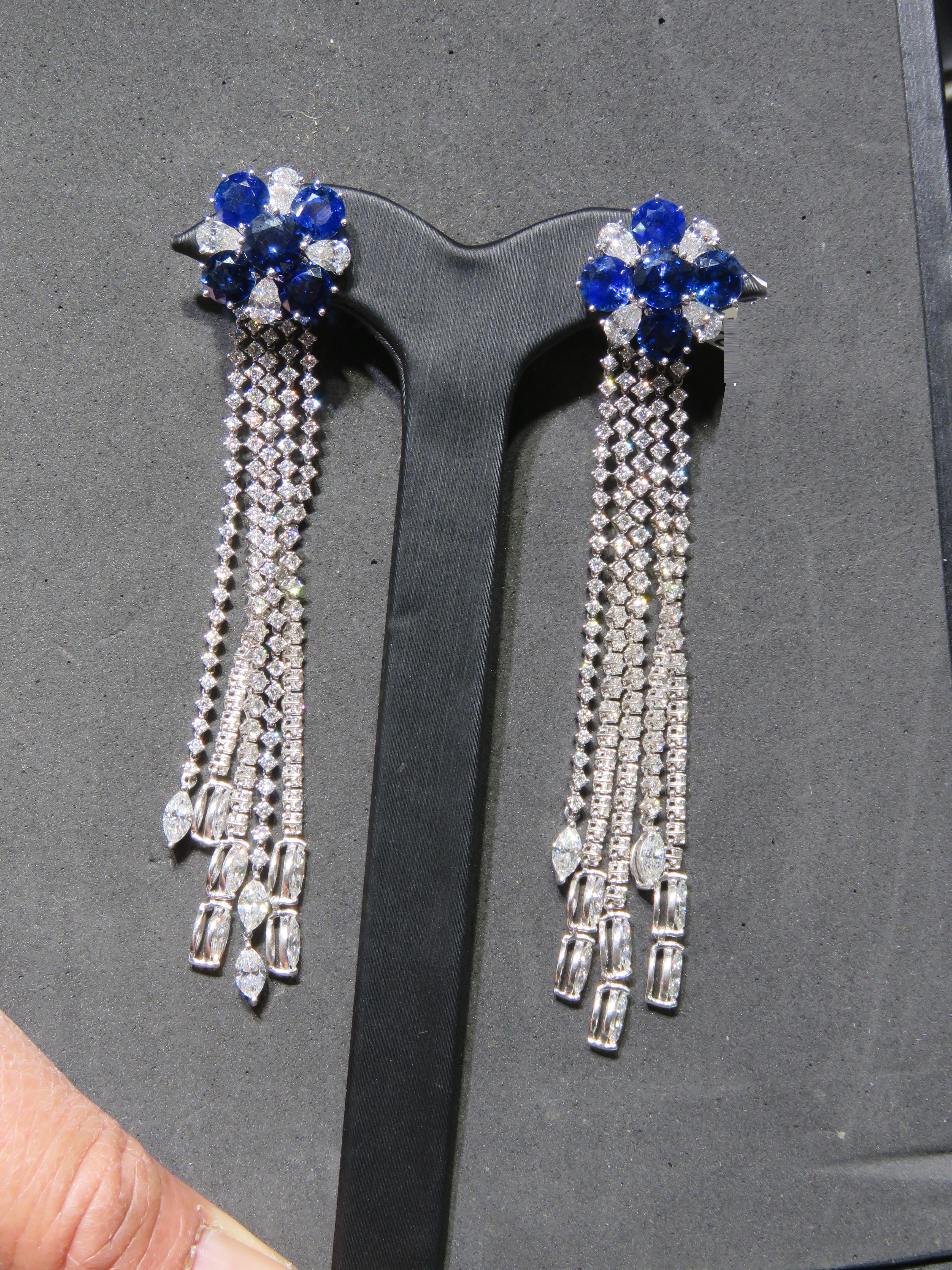 The Following Item we are offering is this Rare Important Radiant 18KT Gold Gorgeous Glittering and Sparkling Ceylon Blue Sapphire Diamond Dangle Earrings. Earrings Contains approx 26CTS of Beautiful Fancy Blue Sapphires and Fancy White Diamonds in