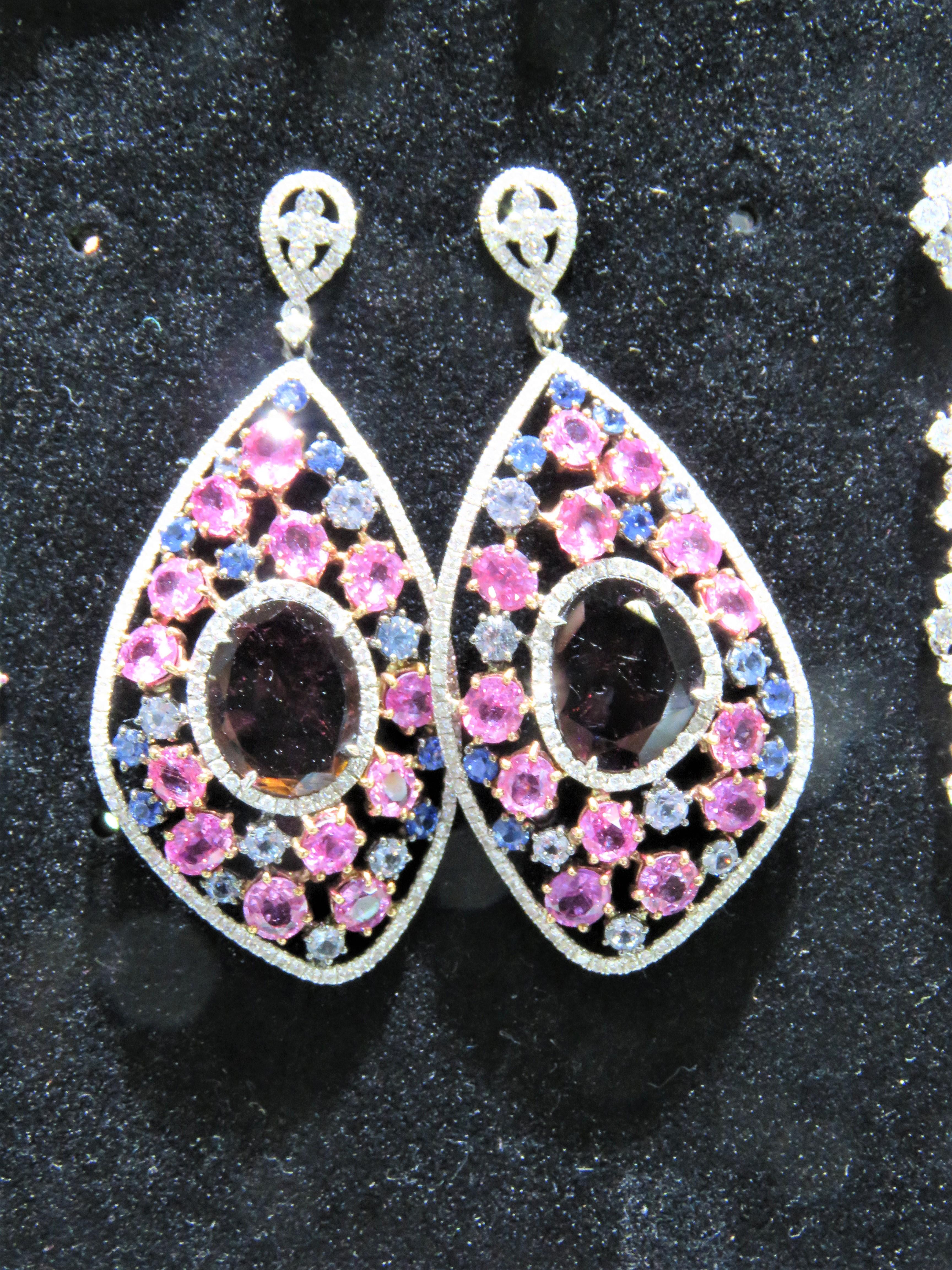 The Following Items we are offering is this Rare Important Radiant 18KT Gold Gorgeous Glittering and Sparkling Magnificent Fancy Rainbow Multi Color Spinel Diamond Dangle Earrings. Earrings contain approx 25CTS of Beautiful Fancy Amethyst Colored