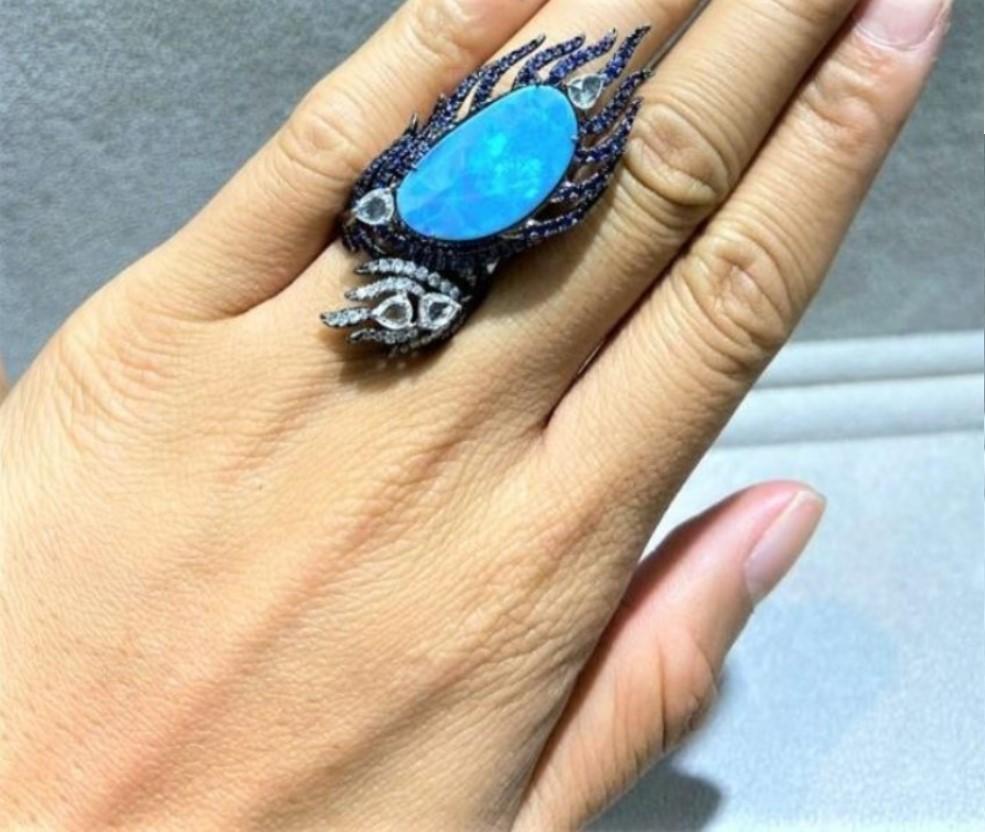 The Following Item we are offering is a Rare Important Radiant 18KT Gold Glistening Australian Black Opal and Diamond Gorgeous Ring. Ring features a Magnificent Rare Color Changing Black Opal from Australia with 4 Large Exquisite Rose Cut and Round