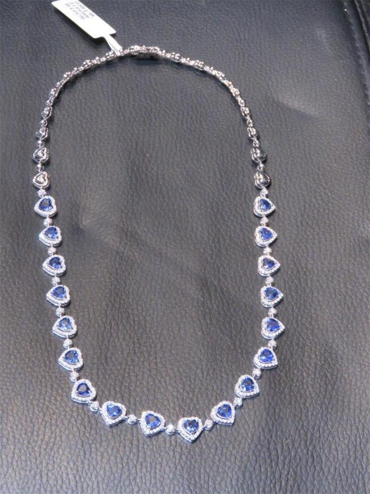 The Following Item we are offering is a Rare 18KT White Gold Blue Sapphire Diamond Heart Necklace. Necklace is comprised of Finely Set Glittering Gorgeous Heart Shaped Sapphires adorned with Diamonds!! The Sapphires and Diamonds are of Exquisite and