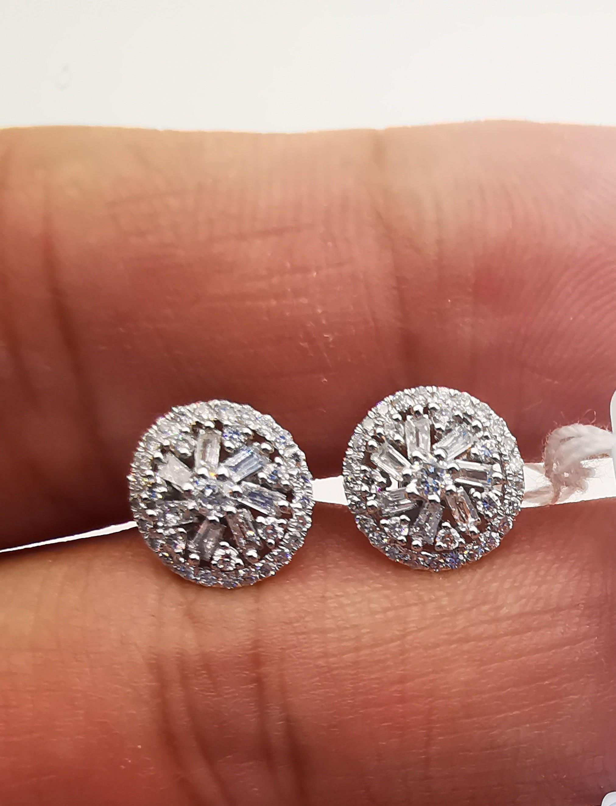 The Following Items we are offering is a Rare Important Radiant 18KT White Gold Stunning Diamond Halo Stud Earrings. Earrings feature Magnificent Rare Sparkling Fine Glittering Trillion Baguette and Round Diamonds!! T.C.W. Approx .50CTS!!! These