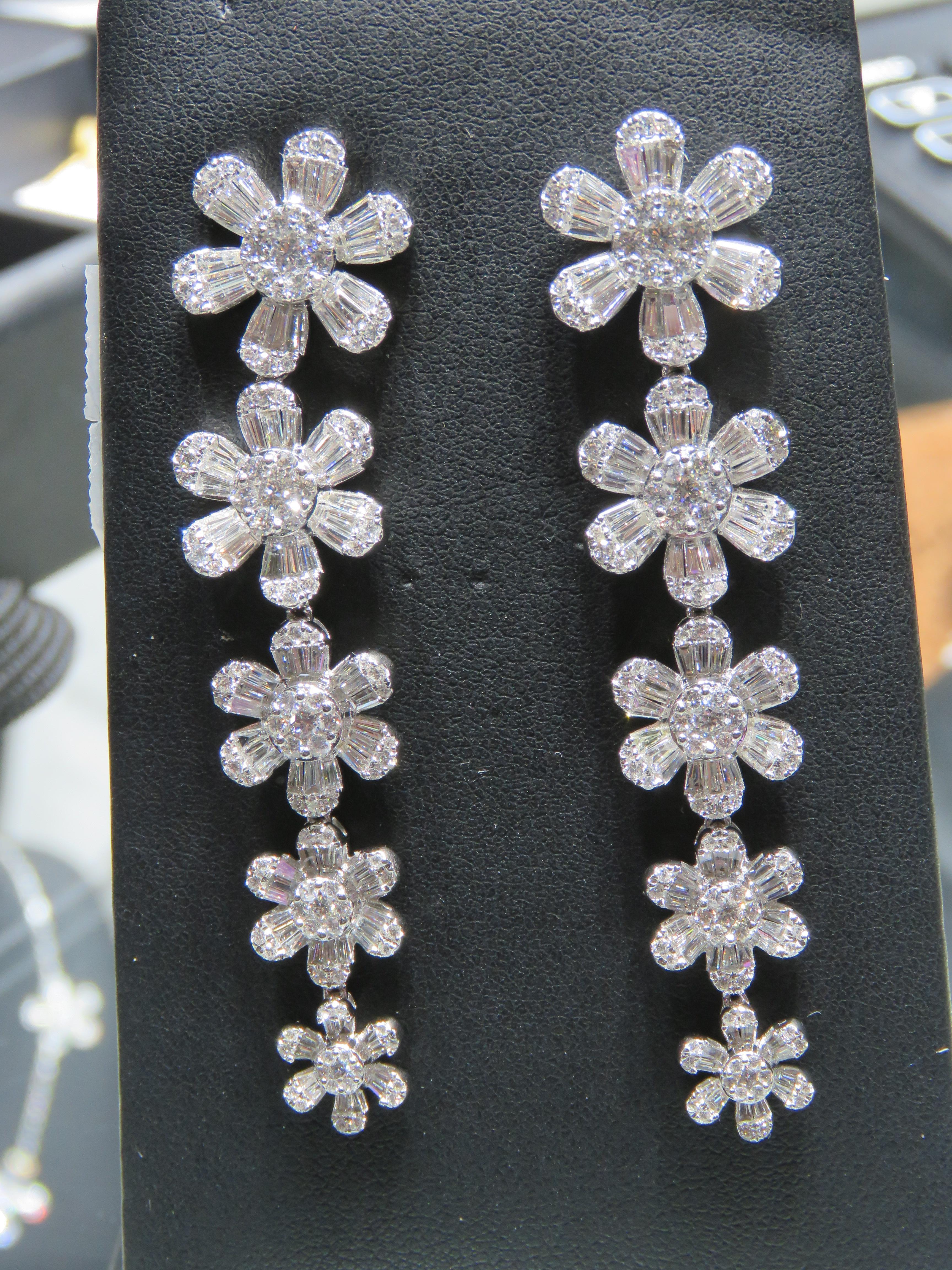 The Following Item we are offering is this Rare Important Radiant 18KT Gold Gorgeous Glittering and Sparkling Diamond Dangle Earrings. Earrings Contains over 5CTS of Beautiful Fancy White Diamonds in the Form of Flowers!!! Stones are Very Clean and