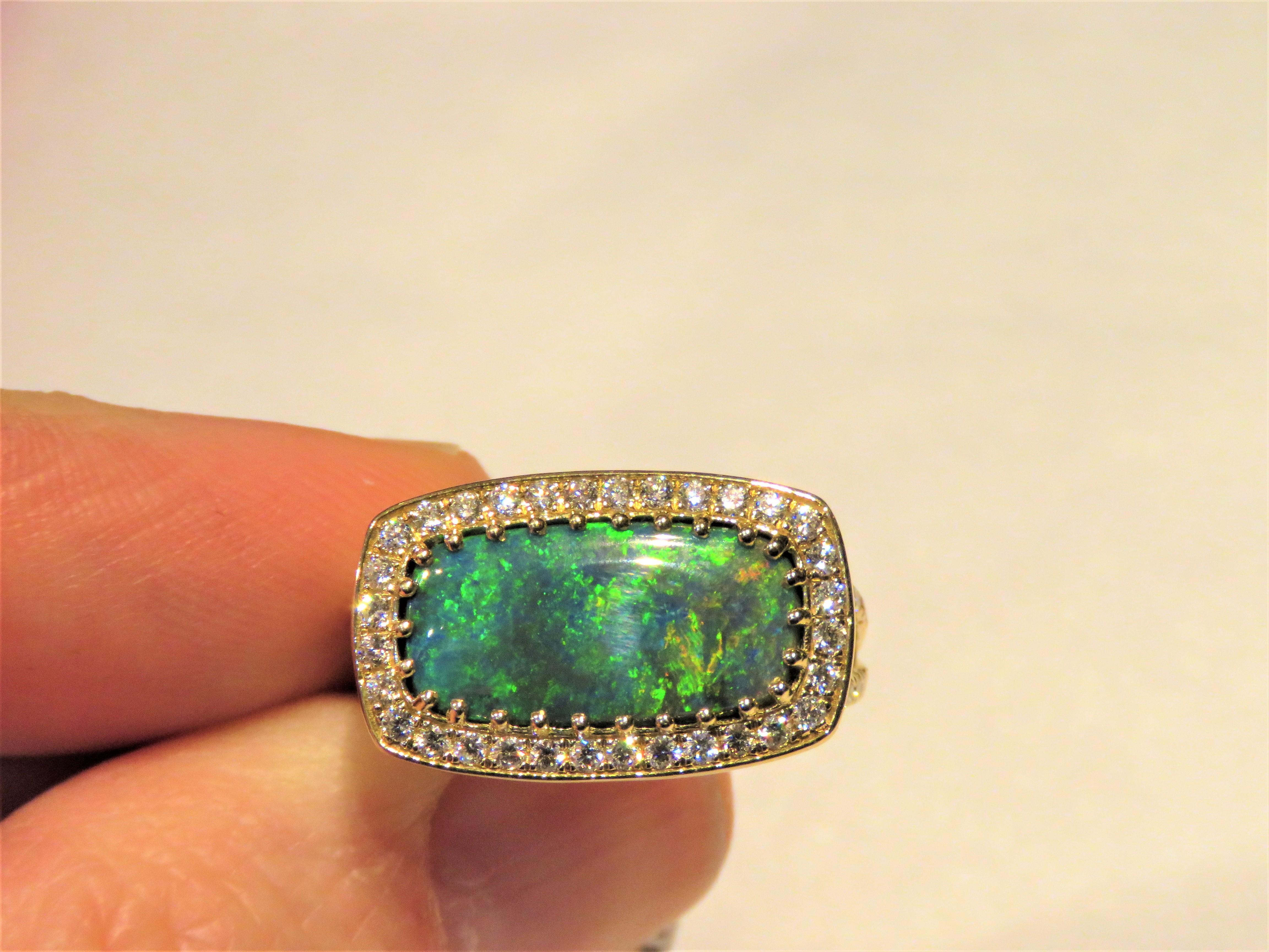 The Following Items we are offering is a Rare Important Spectacular and Brilliant 18KT Gold Large Gorgeous Black Opal Diamond Ring. Ring consists of a Rare Fine Magnificent Rare Lightening Ridge Black Opal surrounded with Gorgeous Glittering