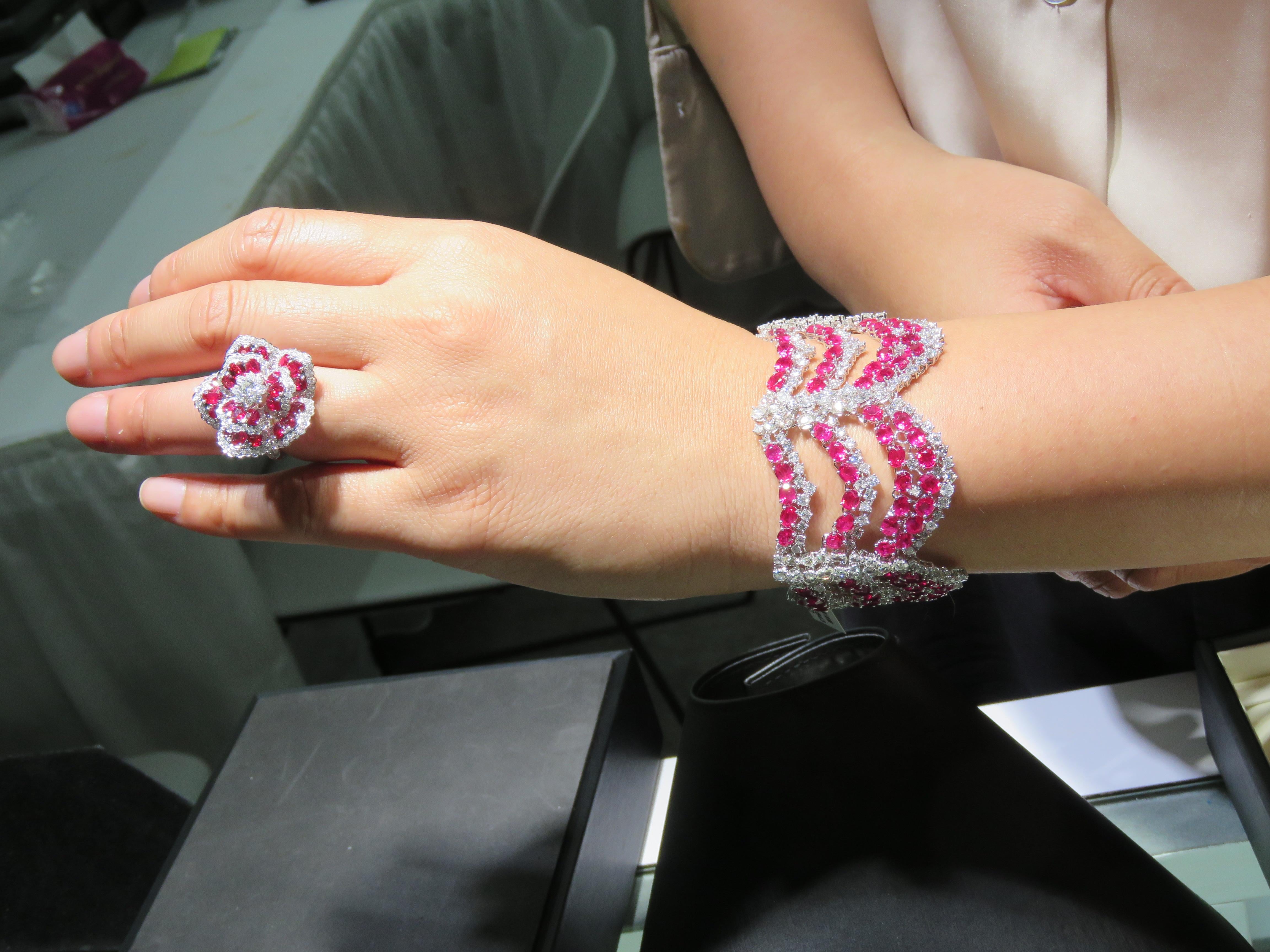 The Following Items we are offering is a Rare Important 18KT White Gold Ruby Diamond Floral Shaped Ring. Ring is comprised of Finely Set Glittering Rubies and Diamonds forming a Flower. T.C.W. Approx 7CTS!! The Rubies and Diamonds are of Exquisite