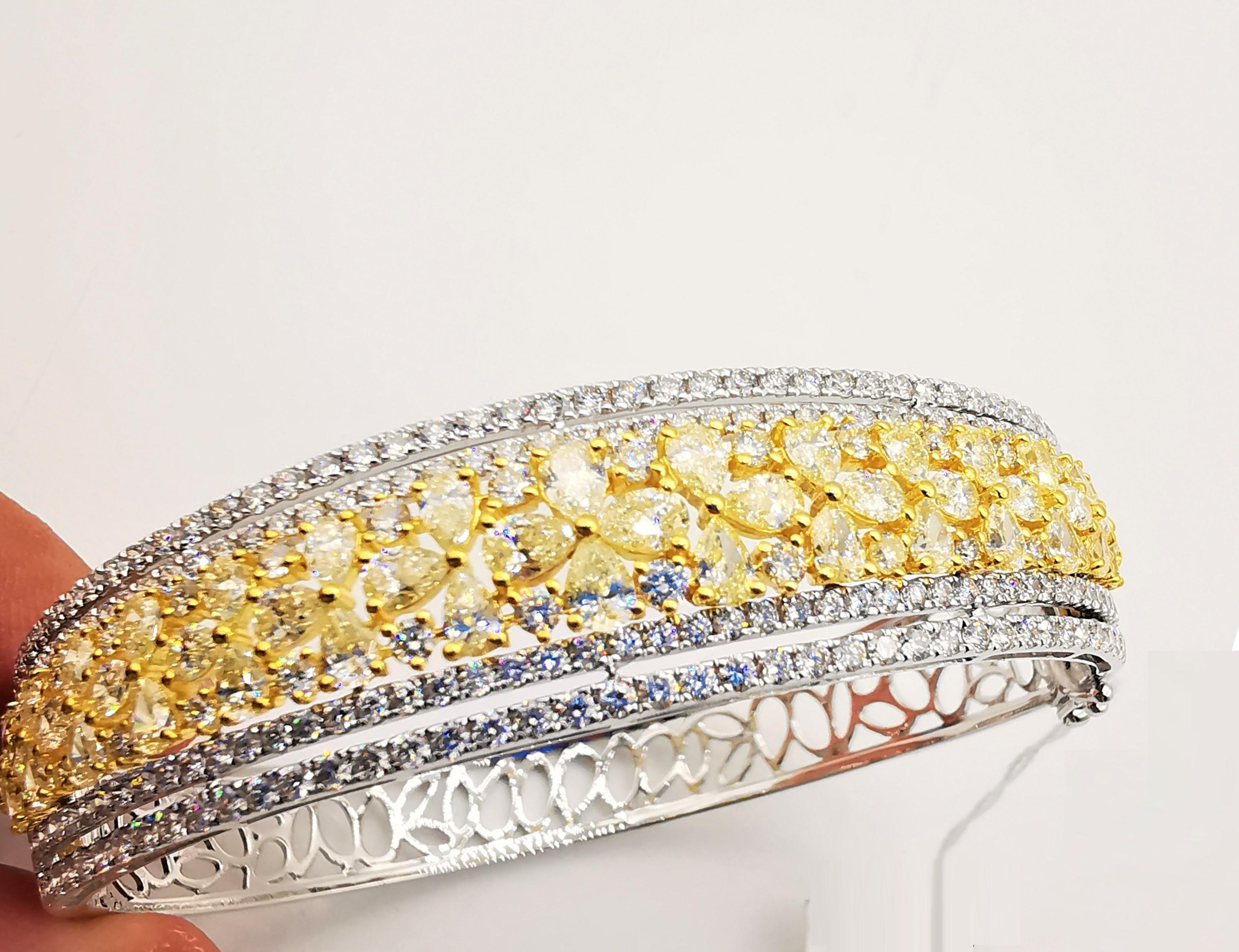 The Following Item we are offering is a Rare Important Radiant 18KT Gold Large Magnificent Rare Fancy Gorgeous Fancy Yellow Diamond and White Diamond Bangle Bracelet. Bangle is comprised of Exquisite Fancy Magnificent Pear Cut Yellow Diamonds