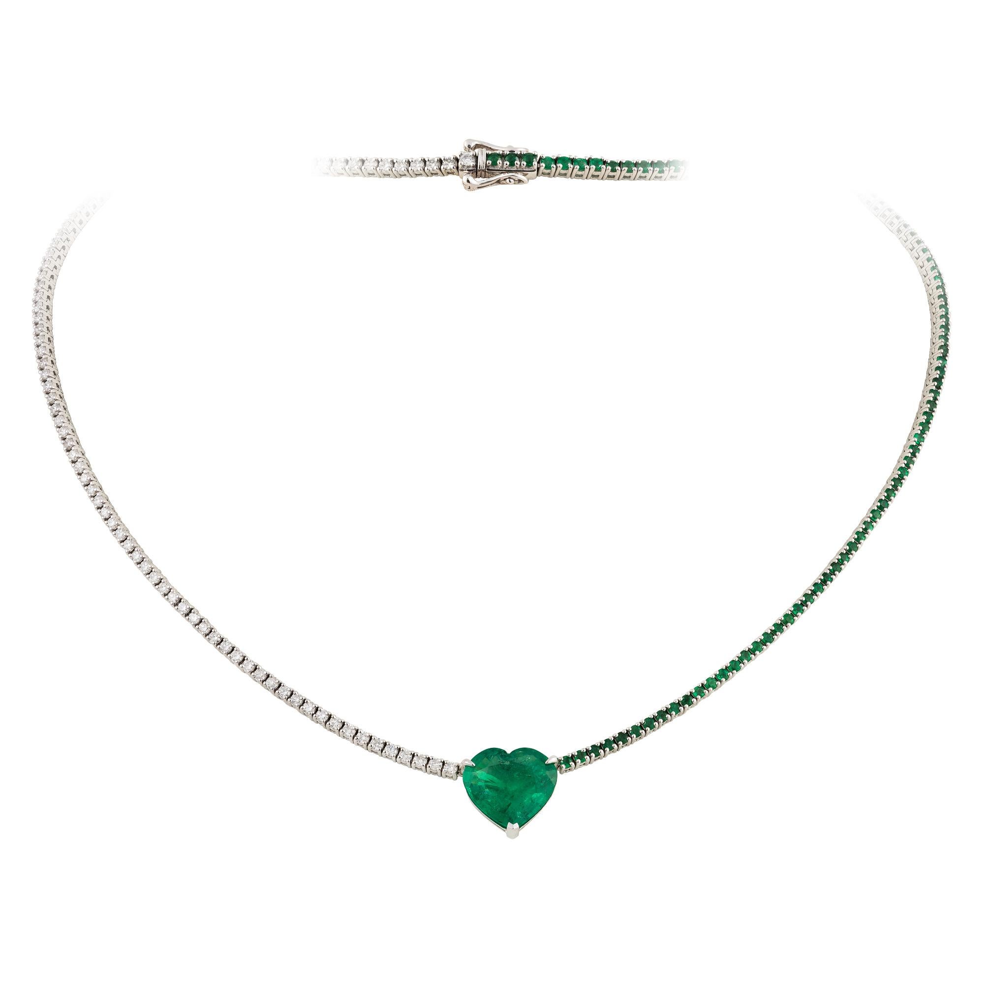 A Rare 18KT White Gold Emerald Diamond Necklace. Necklace is comprised of Finely Set Glittering Gorgeous Heart Shaped Emerald adorned with Diamonds and Emeralds!!! The Emeralds and Diamonds are of Exquisite and Fine Quality. T.C.W. approx 9.50CTS!!!