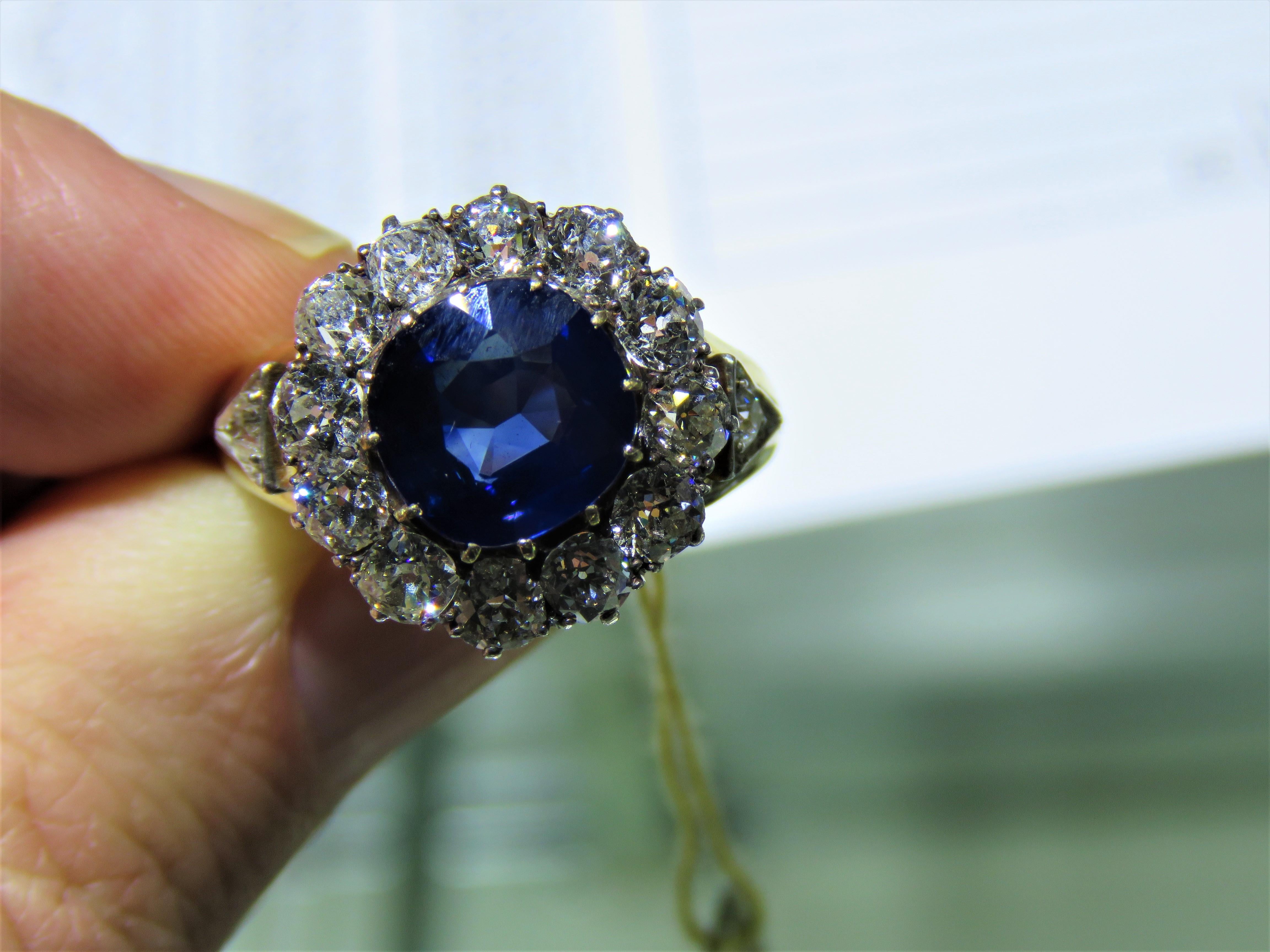 The Following Item we are offering is a Rare Important Radiant 18KT Yellow Gold Large Rare Fancy Blue Sapphire and Diamond Ring. Ring is comprised of a Rare Gorgeous Large Blue Sapphire surrounded by Magnificent Round Cut Diamonds and Trillion