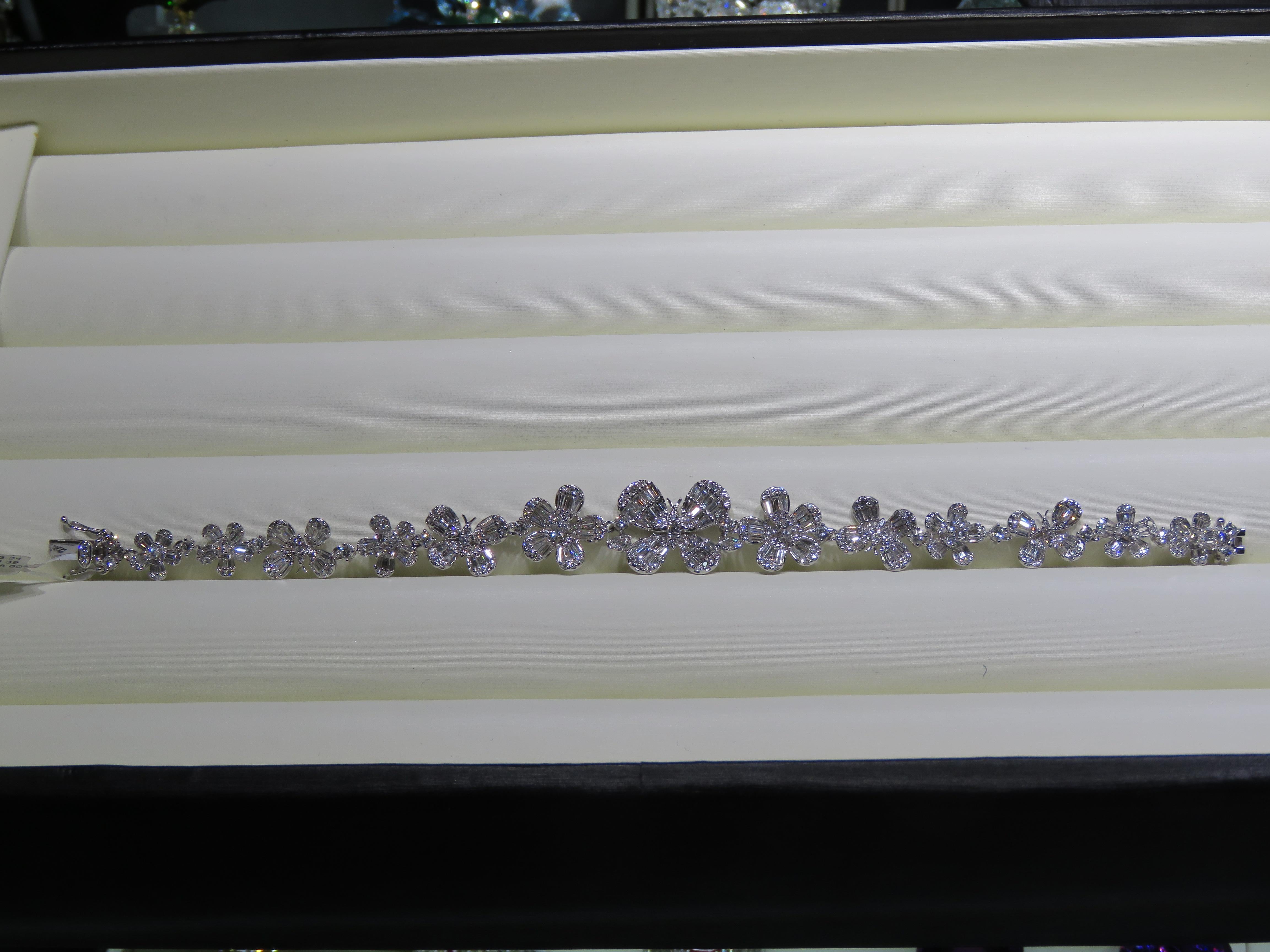 The Following Item we are offering is a Rare 18KT White Gold Multi Flower Diamond Strand Bracelet. Bracelet is comprised of Finely Set Gorgeous Glittering Trillion and Round Diamonds forming a strand of Flowers!!! T.C.W. approx 6CTS!! 
This Gorgeous