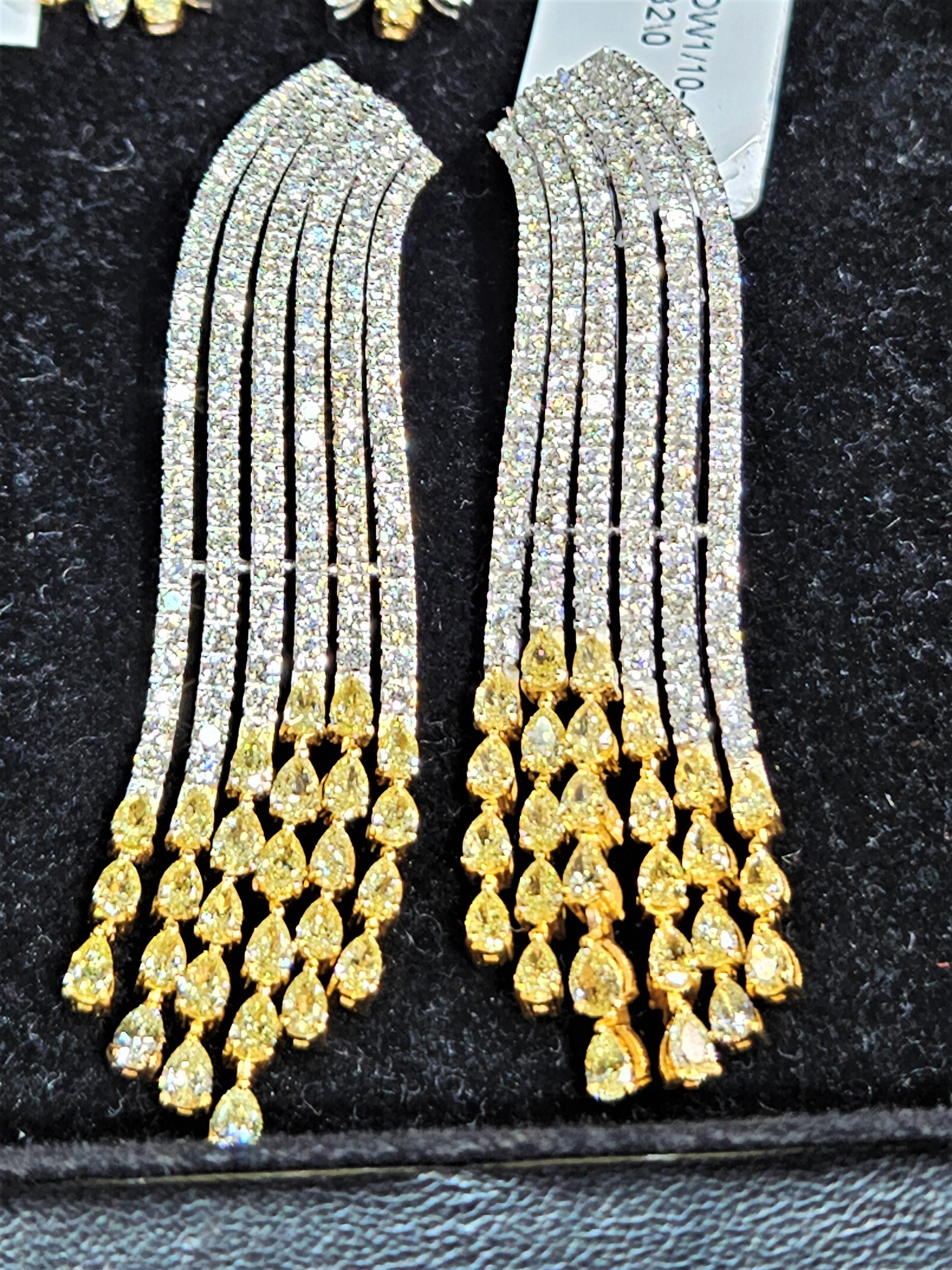 The Following Item we are offering are these Extremely Rare Beautiful 14KT Gold Fine Large Fancy Yellow and White Diamond Dangle Earrings. Each Earring features Rare Gorgeous Glittering Fancy Yellow Diamonds Draped around Sparkling White Diamonds