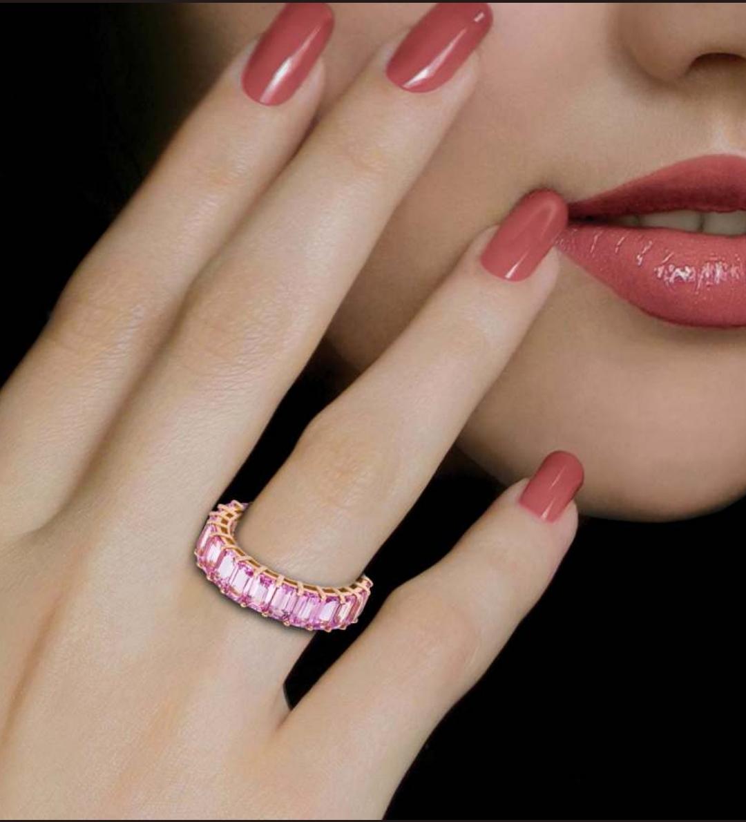 The Following Item we are offering is this Rare Important Radiant 18KT Gold Gorgeous Glittering and Sparkling Magnificent Fancy Emerald Cut Pink Sapphire Ring Eternity Band. Ring Contains approx 7.25CTS of Beautiful Fancy Emerald Cut Pink