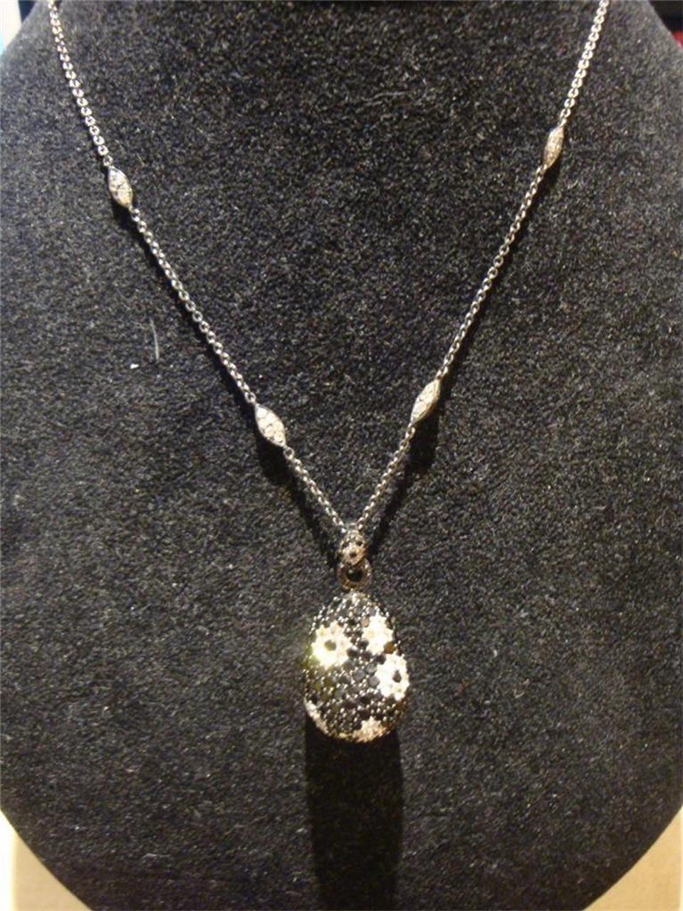 The Following Item we are offering is this Rare Large FANCY WHITE SAPPHIRE FLORAL FLOWER PEAR SHAPED NUGGET WITH BLACK SPINEL. T.W. 14 1/2 CTS. This Pendant. was Beautifully designed with Floral Motifs throughout. The chain is also adorned